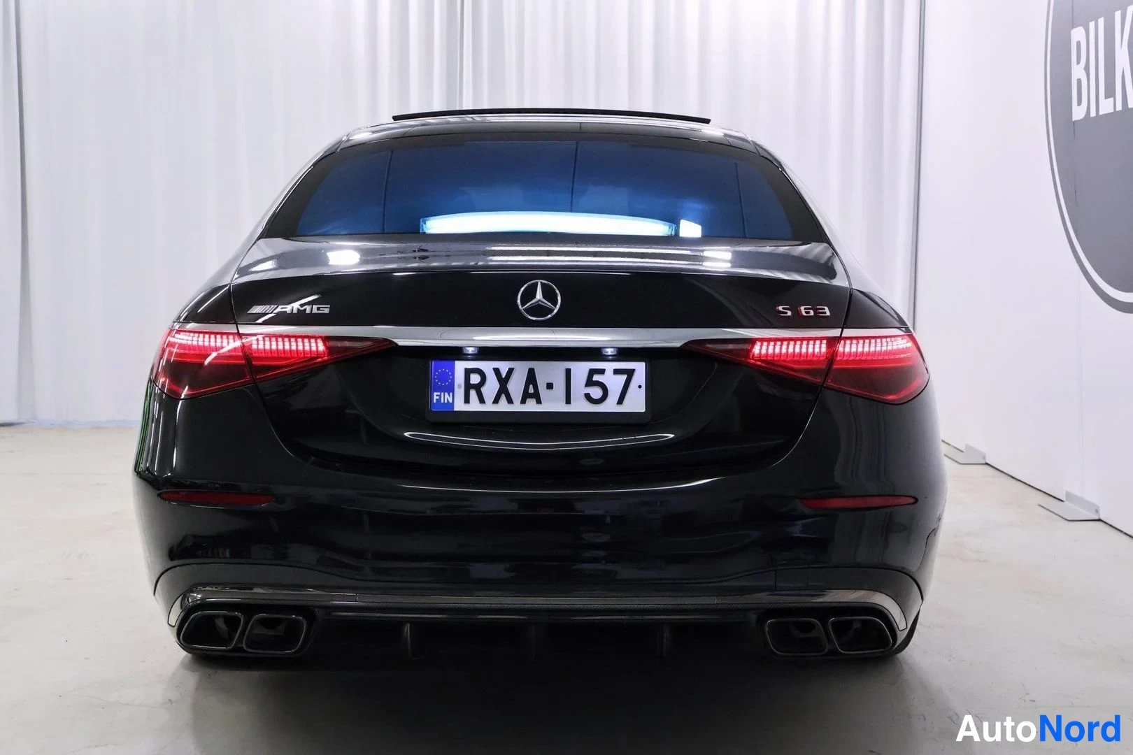 Takaa: Mustan Mercedes-Benz S 63 AMG:n takanäkymä, rekisterikilpi ja neljä pakoputkea.