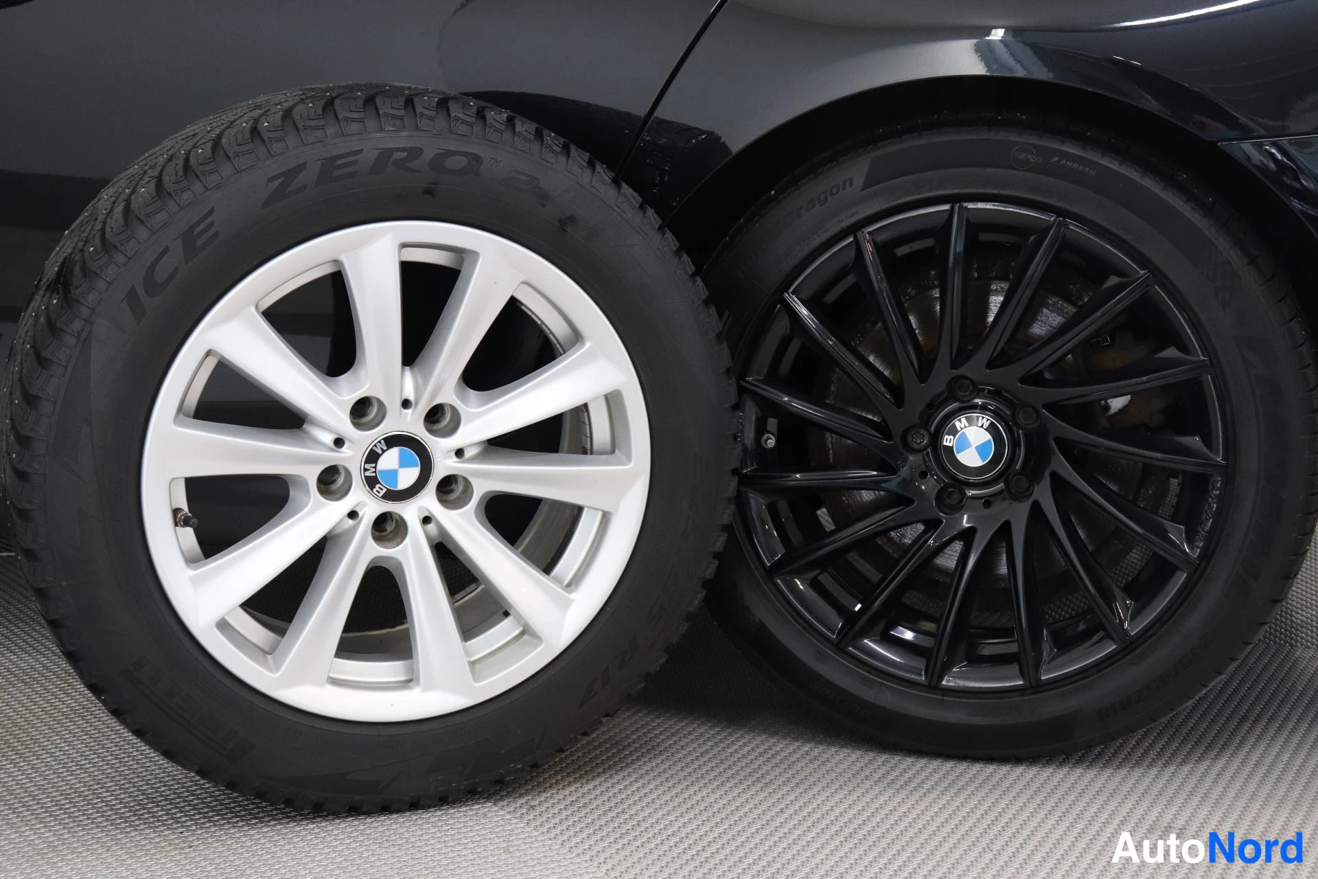 Muu: Side-by-side comparison of two BMW wheels: one fitted with winter tyre branded 'ICE ZERO 2' mounted on silver multi-spoke alloy rim; the other equipped with sum
