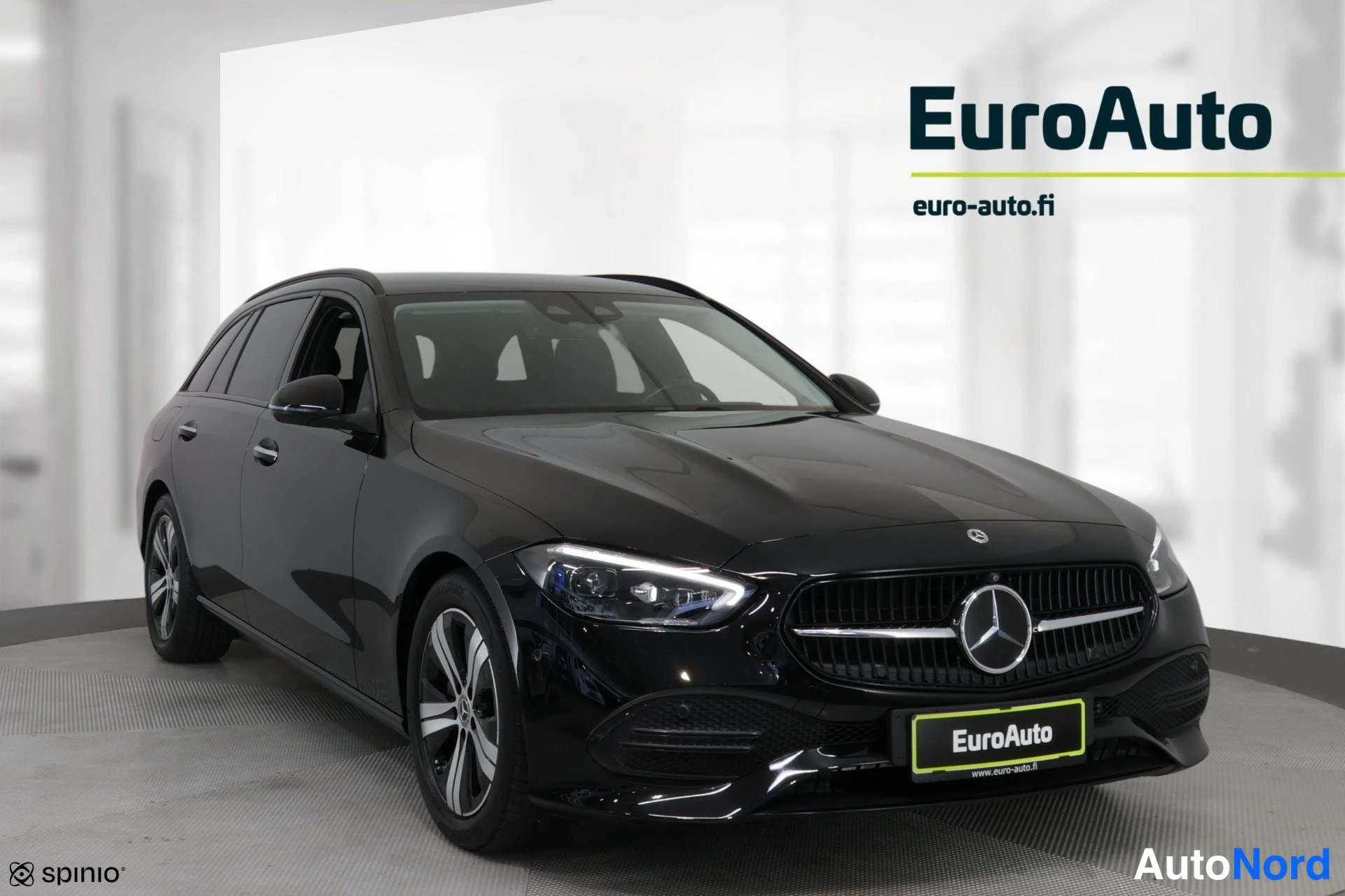 Etuviisto, nokka oikealle: Musta Mercedes-Benz-farmari kuvattuna etukulmasta, keula oikealla, valkoisessa studiossa.