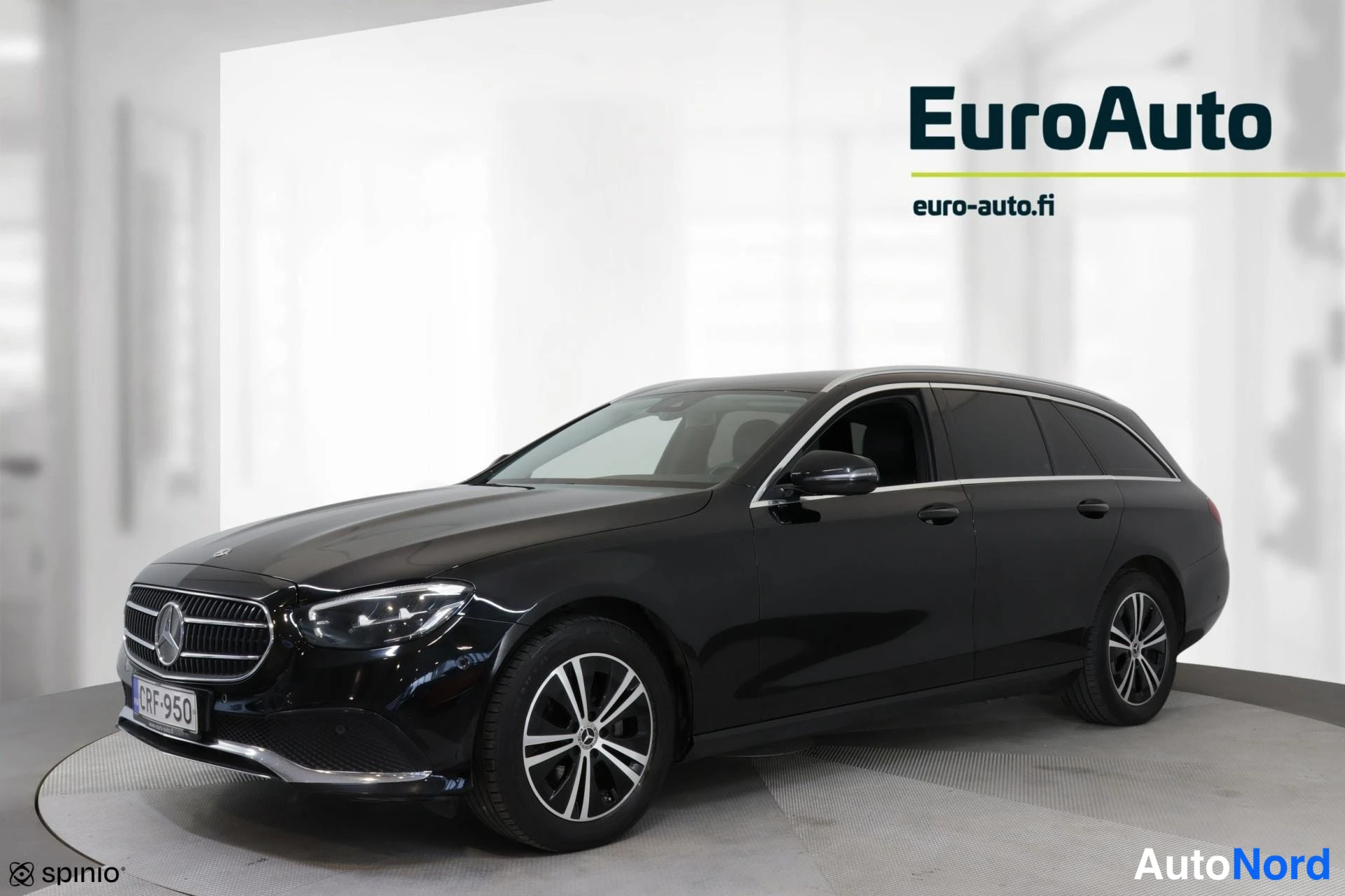 Sivulta: Musta Mercedes-Benz -farmariauto kuva puoliväriltä. Oikea sivu on selvästi näkyvissä, mutta takaosa ei ole kuvan pääosassa. Takalaatta ja EuroAuto logo näkyvät.