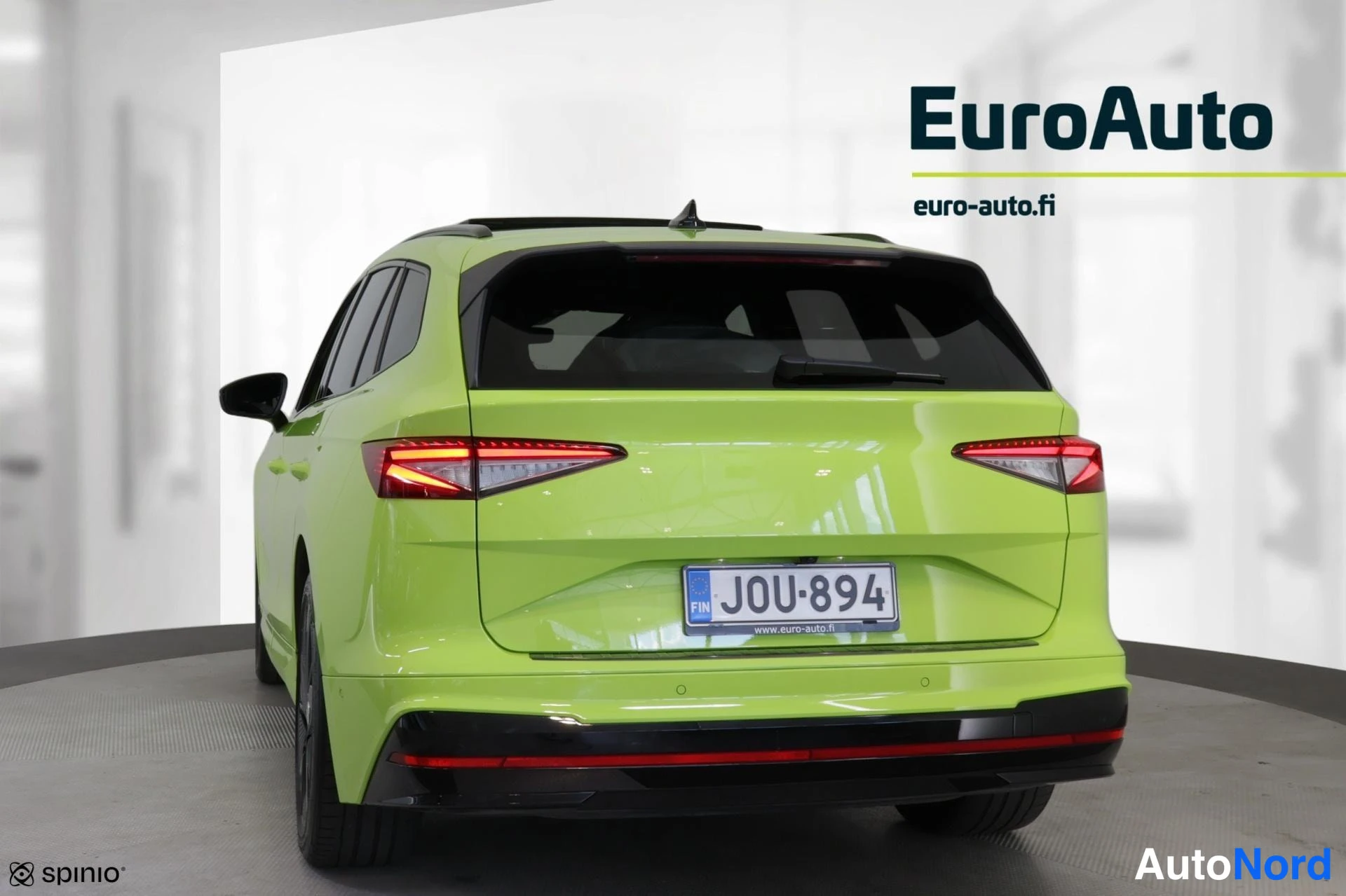 Takaviisto: Rear three-quarter view of a lime green SUV showing tail lights and rear bumper; watermark text reads EuroAuto