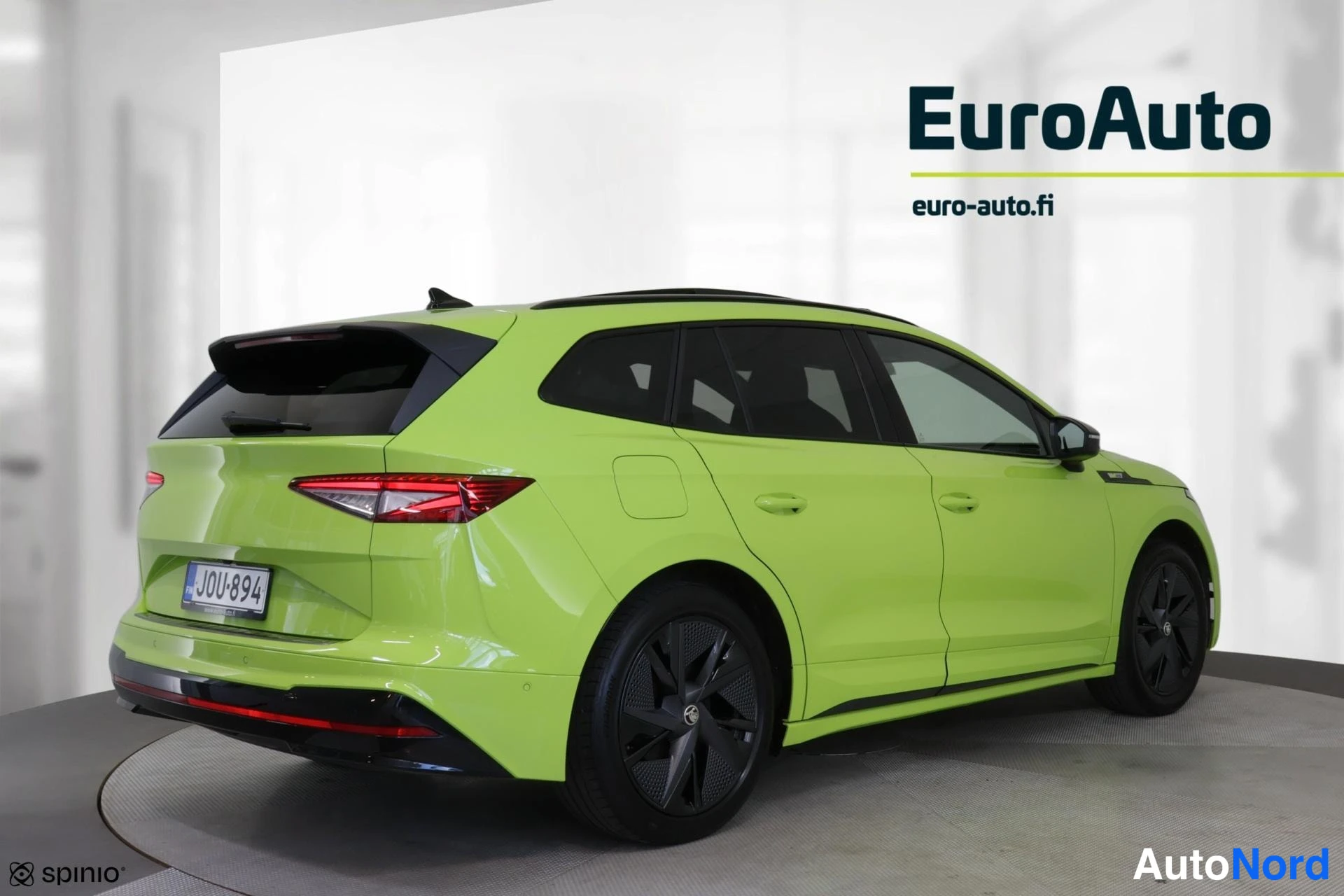 Takaviisto: Rear three-quarter side view of a lime green SUV showing flank and rear; watermark text reads EuroAuto