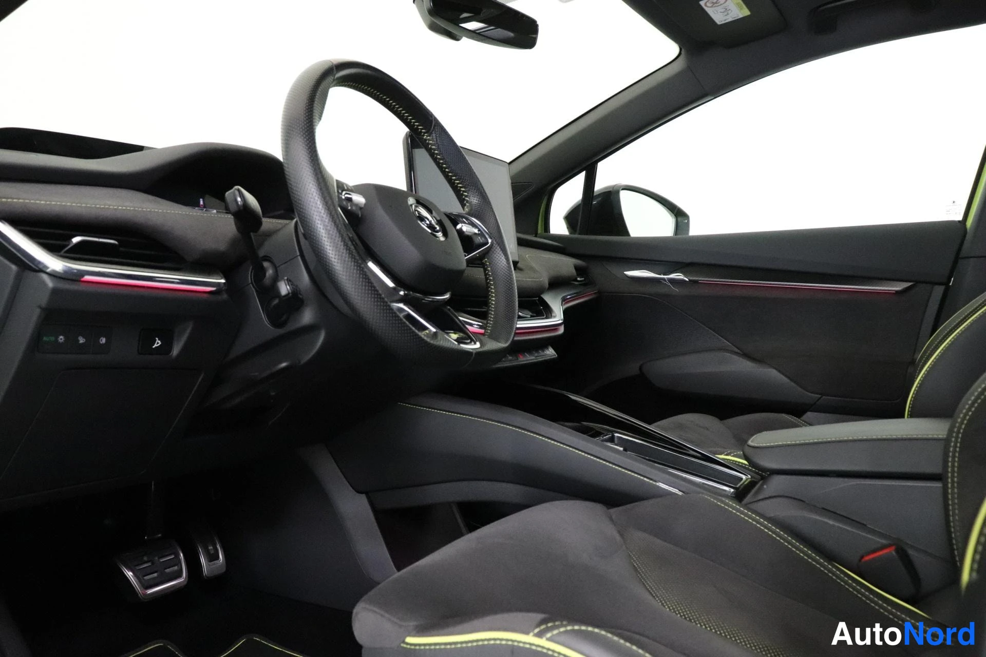 Ohjaamo: Interior cabin view showing the steering wheel with buttons, dashboard, and driver seat; ambient lighting strip visible on dash.