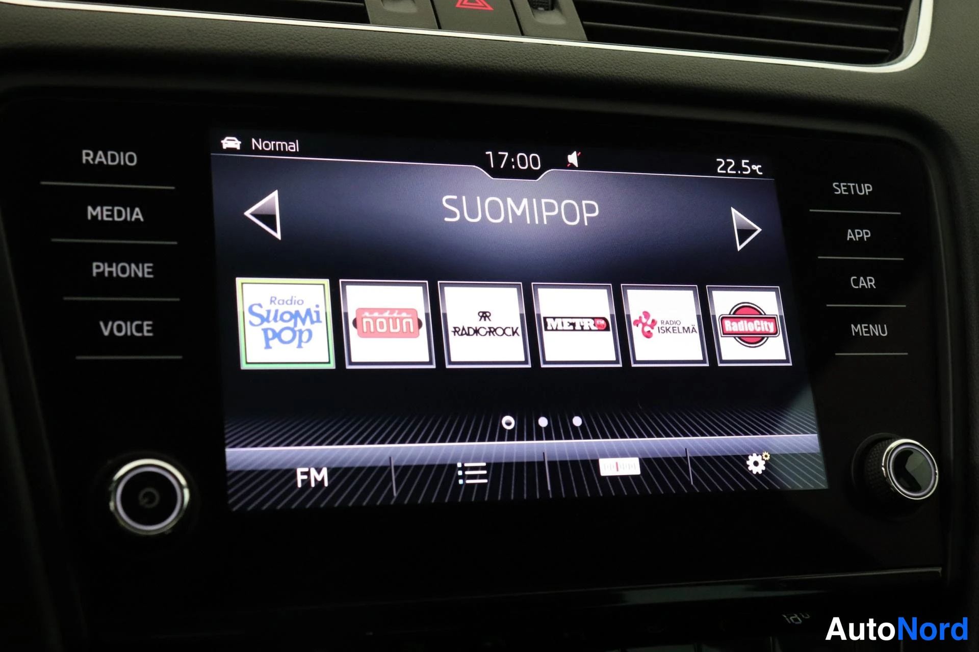 Yksityiskohta: Infotainment-näytön radiovalikko SUOMIPOP kanavapainikkeilla Radio SuomiPop, Noun, Radio Rock, Metro, Radio Iskelmä ja Radio City; kello 17:00, lämpötila 22,5 °