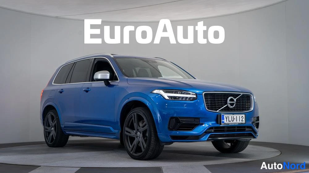 Etuviisto, nokka oikealle: Kirkasvaloisessa studiossa otettu etuvuoro kuva kaksivärisestä sinisestä Volvo XC90 -maastorikasta. Etusuoja on mustaa korin muotoiltua pientä alumiiniva