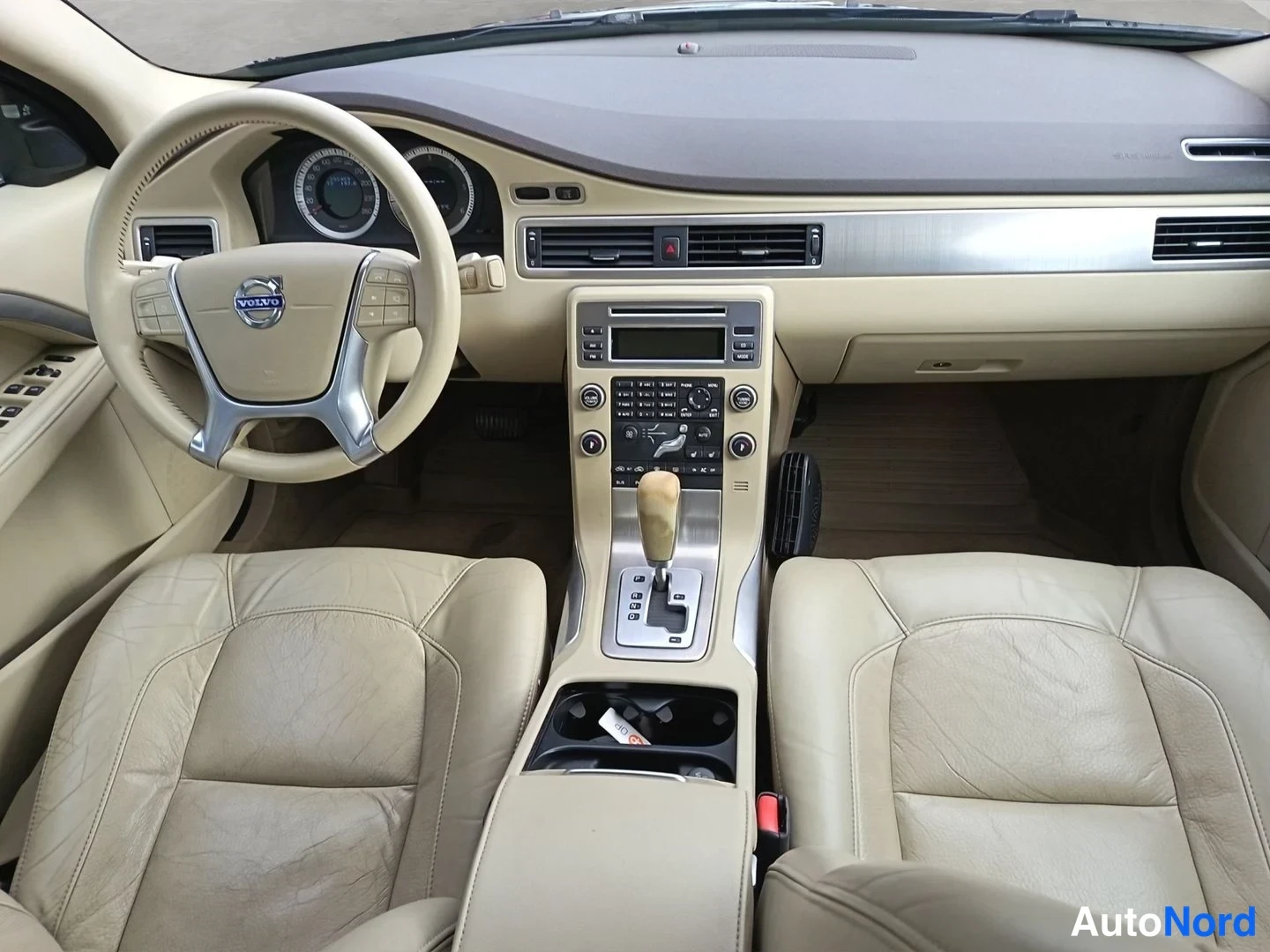 Muu: Direct frontal shot of the dashboard. Features a central infotainment screen, climate control vents, and a dual-zone climate control system below the vents with