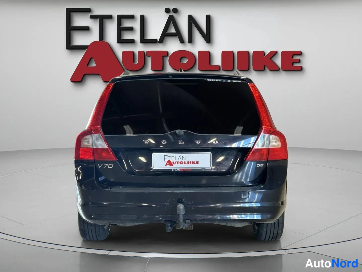 Takaa: Mustan farmariauton takaosa, V70- ja D5-merkit, Etelän Autoliike -logo taustalla.