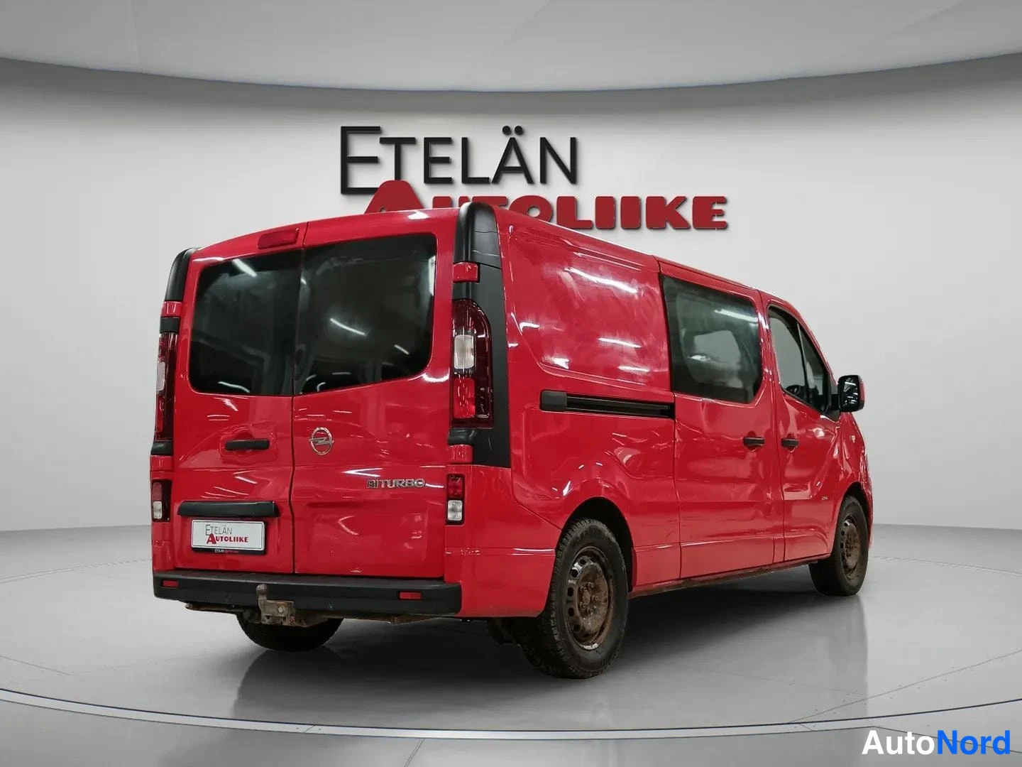 Takaviisto: Punainen pakettiauto takaviistosta, Etelän Autoliike -tausta