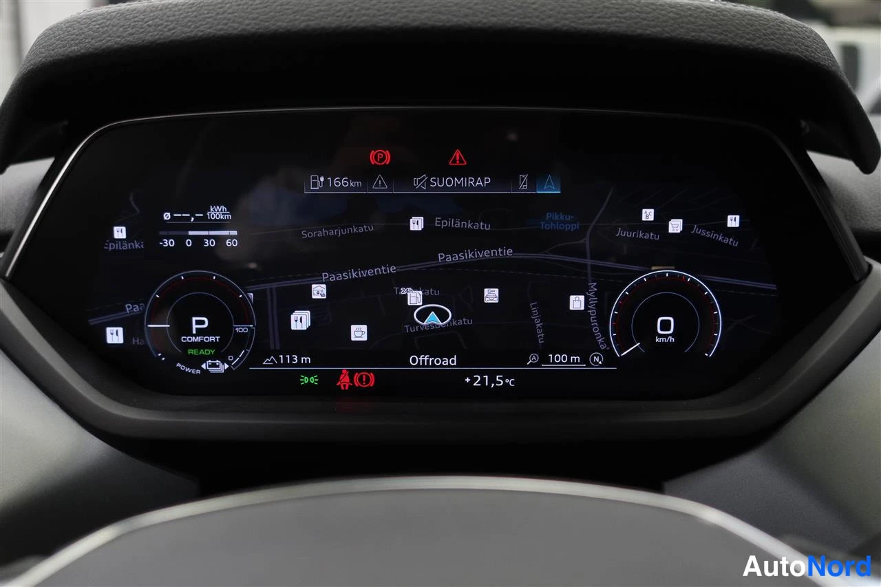 Yksityiskohta: Digitaalinen kuljettajan näyttö: kartta, vaihde P, valmiustila READY, nopeus 0 km/h, lämpötila +21,5 °C ja etäisyys 166 km.