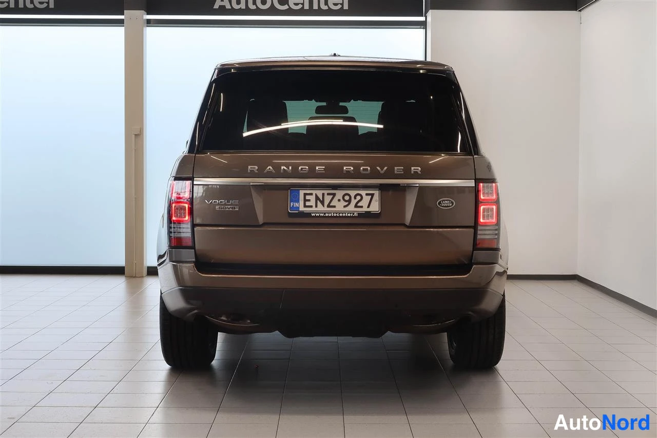 Takaa: Suora takaa-ajokuva ruskeahkosta Land Rover Range Roverista, rekisteritunnus.