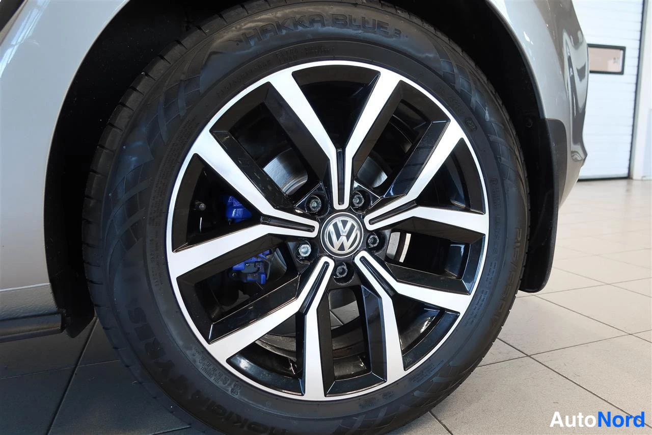 Yksityiskohta: Volkswagenin kevytmetallivanteen lähikuva, Nokian Hakka Blue 3 -kesärengas ja sininen jarrusatula näkyvissä.
