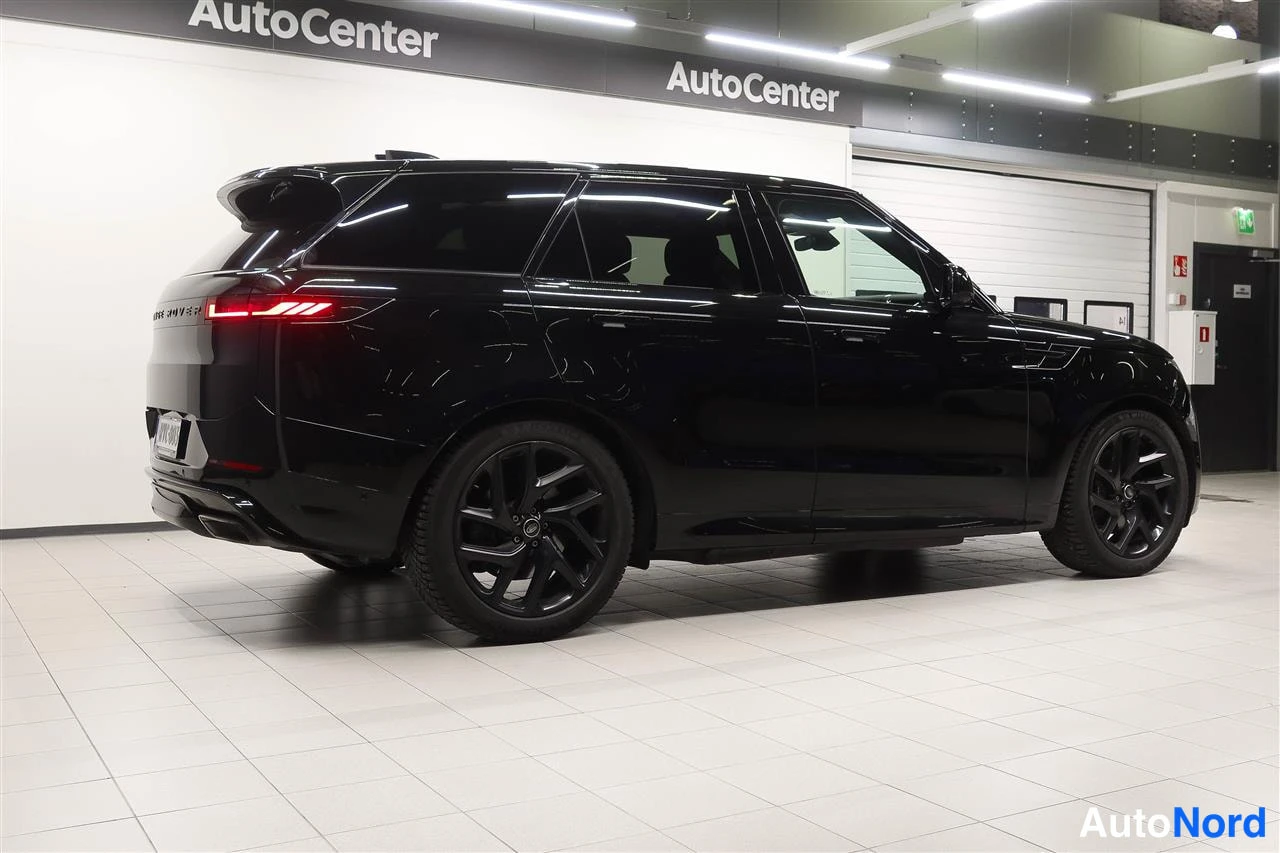 Takaviisto: Musta Land Rover Range Rover Sport takaviistosta kuvattuna autotallin sisällä; näkyvissä takavalot, rekisterikilpi, molemmat sivut ja tummat kevytmetallivanteet