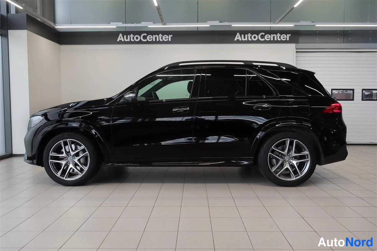 Takaviisto: Mustan Mercedes-Benz GLE:n sivuprofiili oikealta; tummat ikkunat, kattokaiteet ja hopeiset monipolttoiset vanteet.
