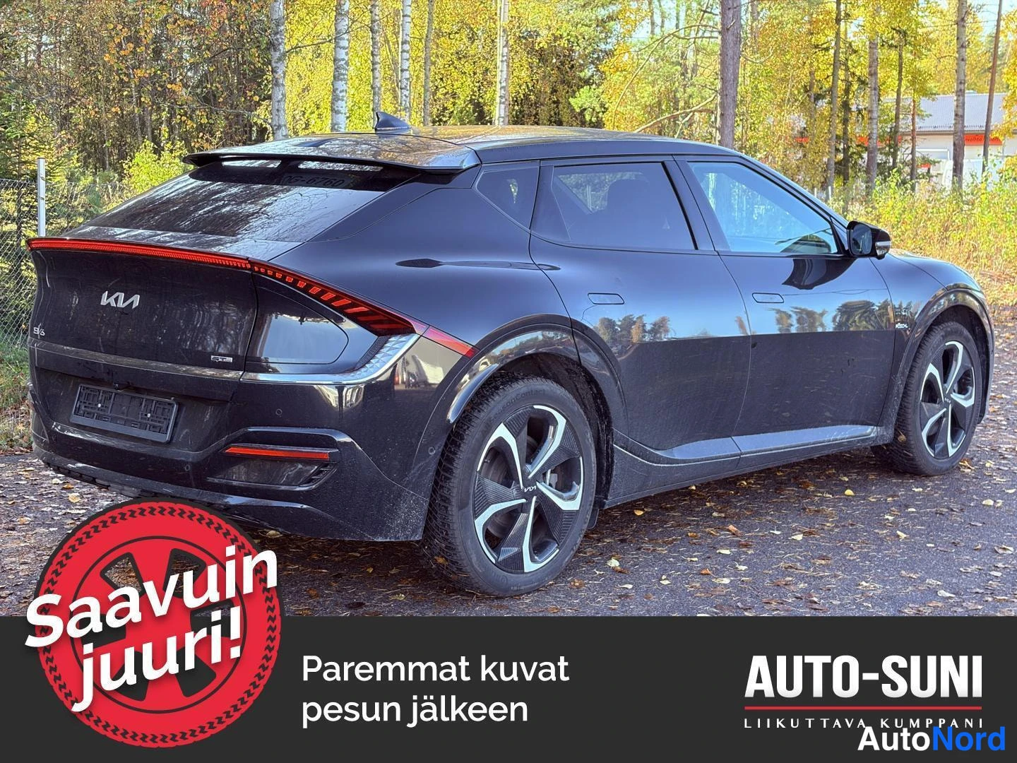 Takaviisto: Mustan Kia EV6:n takaviisto vasemmalta, neljä pyörää ja takavalojen viiva näkyvät. Kuva sisältää mainostekstin 'Saavuin juuri!' ja teksti 'Paremmat kuvat pesun