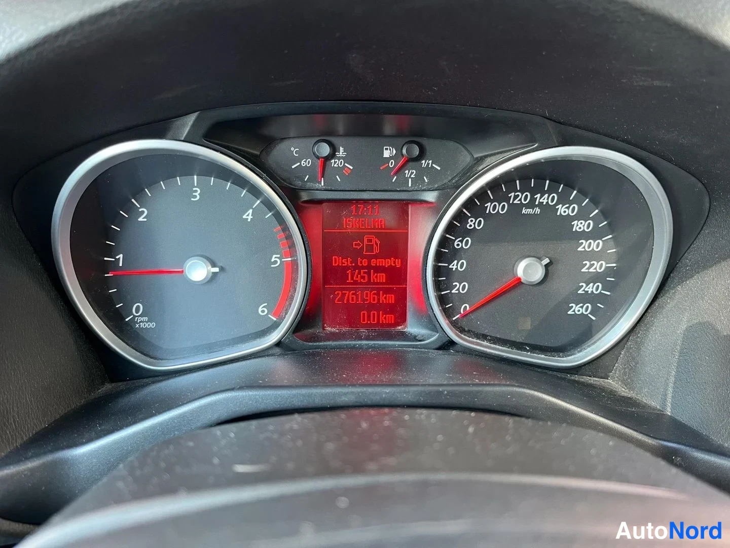 Muu: Kojelaudan mittariston lähikuva; ruudulla näkyy tuloilman lämpötila ja Matkakm-mittari 276 196 km.
