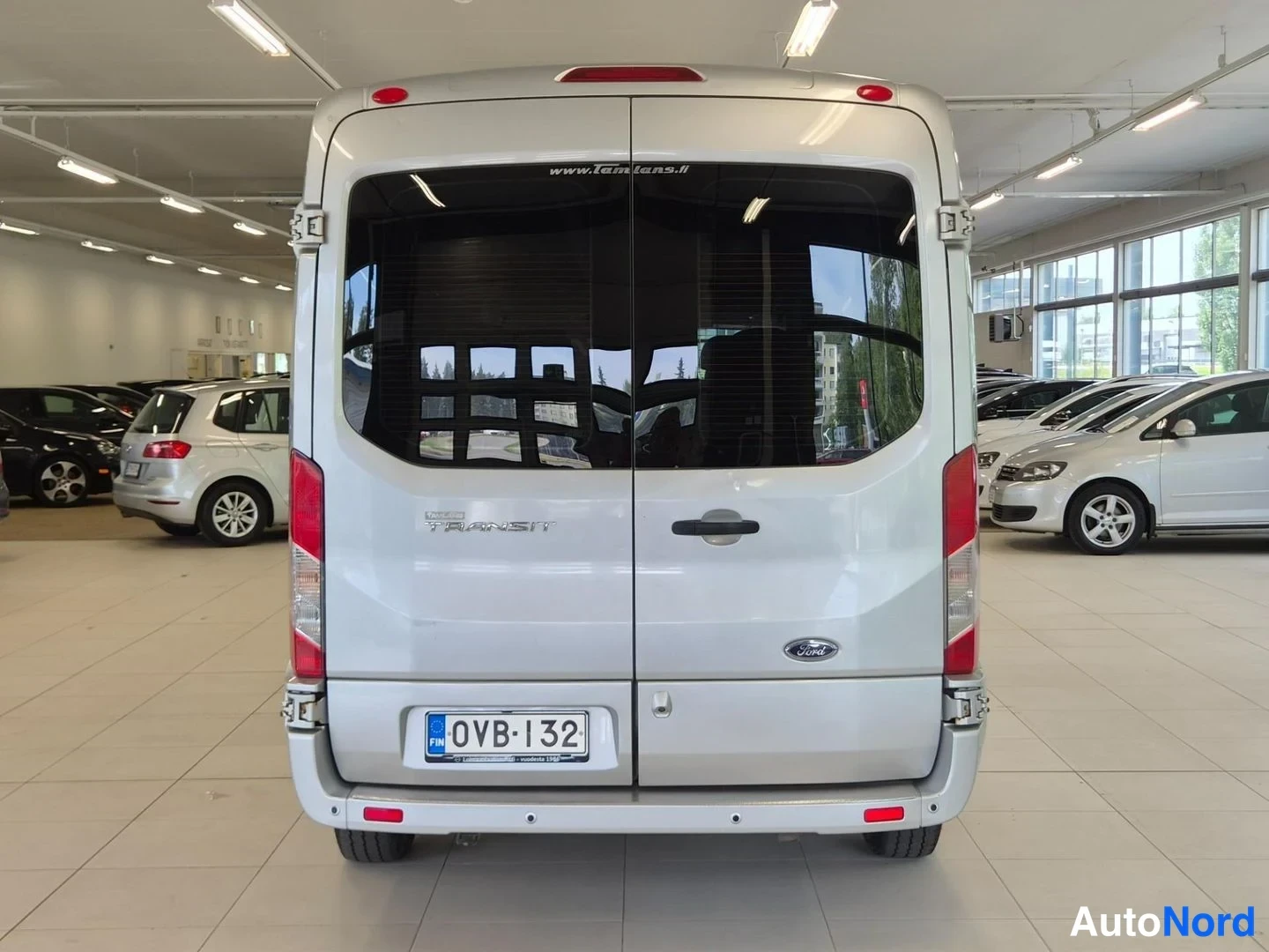 Takaa: Ford Transit -pakettiauton takanäkymä sisätiloissa, takaluukut, TRANSIT-teksti, Ford-merkki ja rekisterikilpi