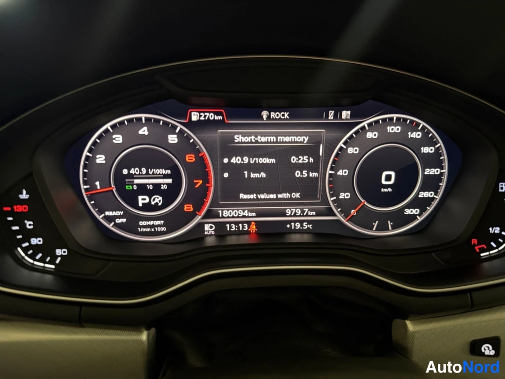 Yksityiskohta: Mittariston digitaalinäyttö lähikuvassa: 180094 km, automaattivaihteen P-tila ja kulutus 40.9 l/100 km.