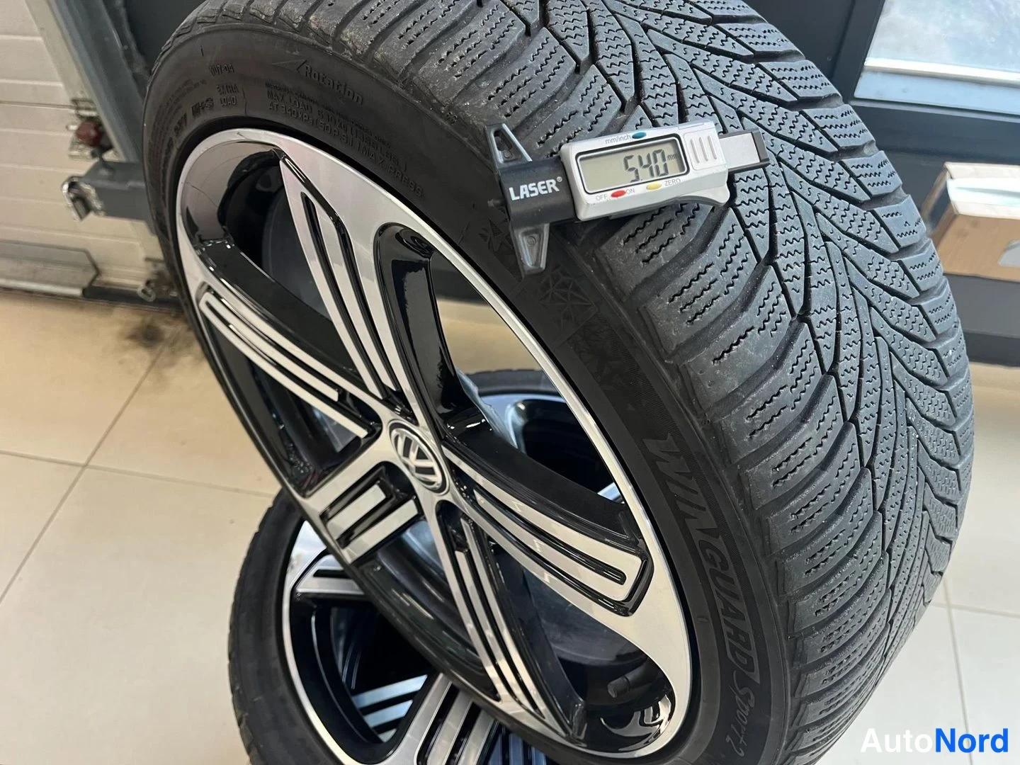 Yksityiskohta: Nokian WINGUARD Sport -talvirengas kaksiv&auml;risell&auml; VW-alumiinivannella, urasyvyysmittarin LASER-n&auml;ytt&ouml; lukee 5,40 mm.