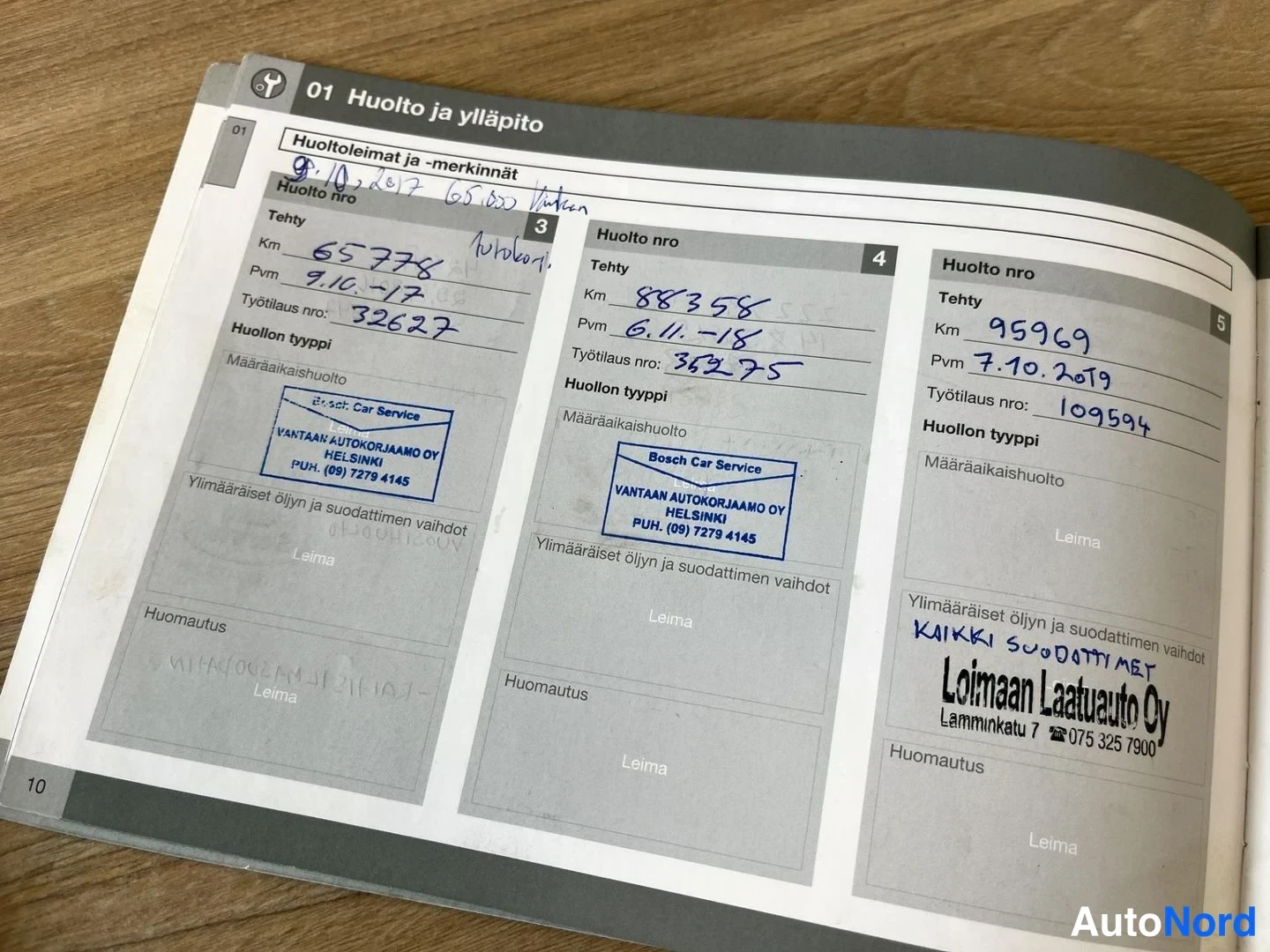 Asiakirja: Another page from the vehicle's service booklet, displaying three maintenance stamps. Entries are visible for services performed on October 9, 2017 (65,778 km),