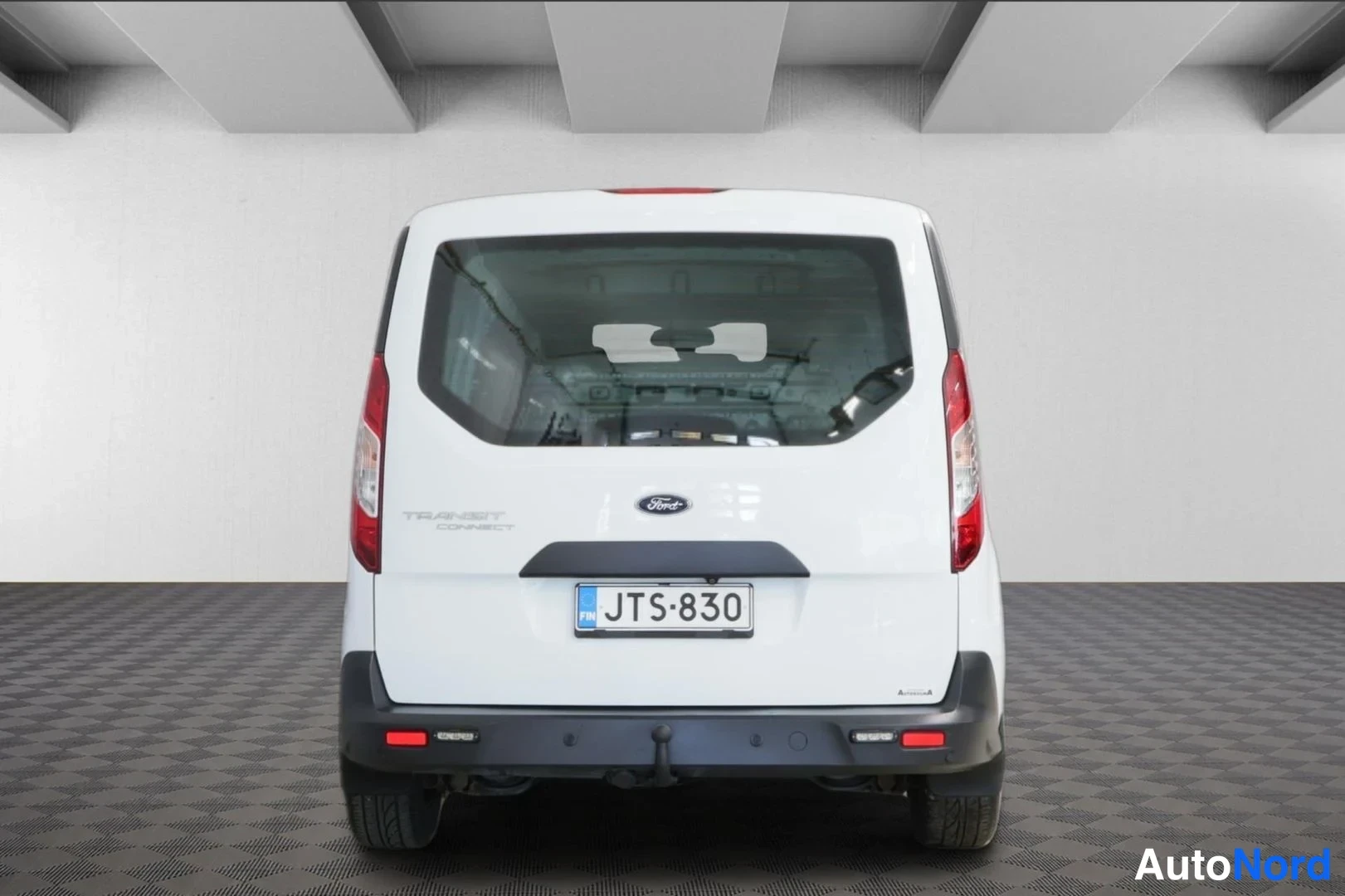 Takaa: Ford Transit Connect -pakettiauton takanäkö, valkoinen korimaa, rekisterikilpi, Ford-merkintä ja Ison-Britannian EU-kilpi takaluukussa.