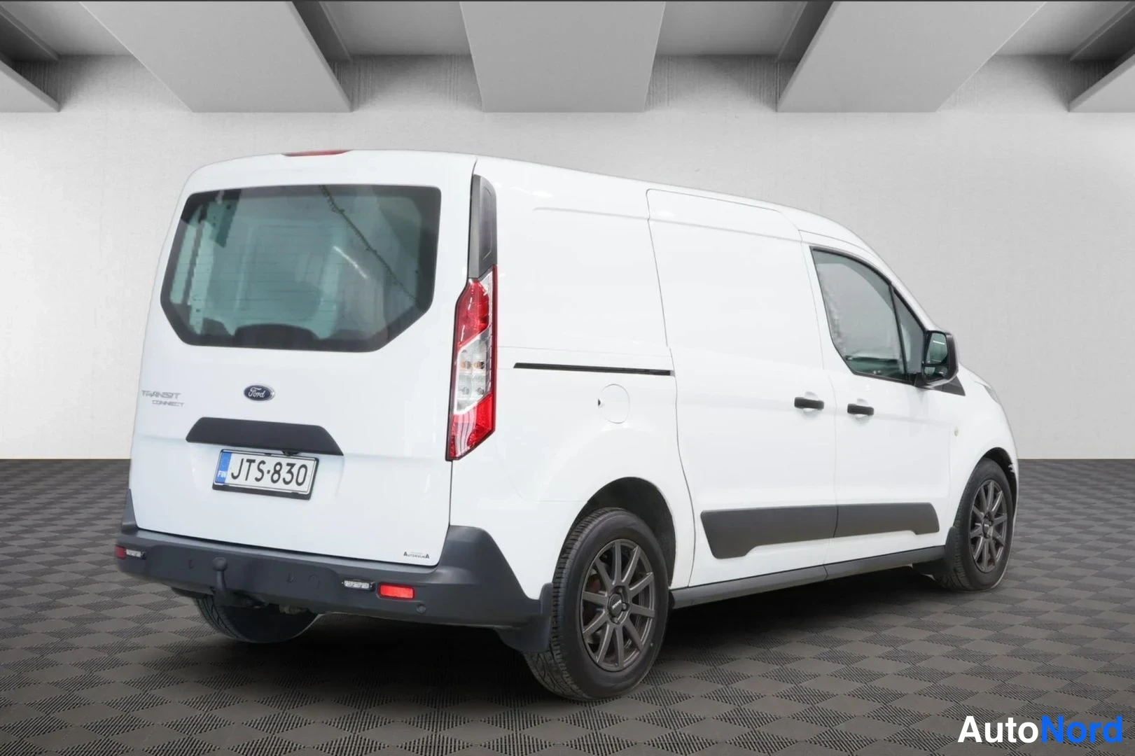 Takaviisto: Ford Transit Connect -pakettiauton takakiiltokuva oikealta, valkoinen korimaa, rekisterikilpi, liukuoikea sivuovi ja takana tummat vanteet.