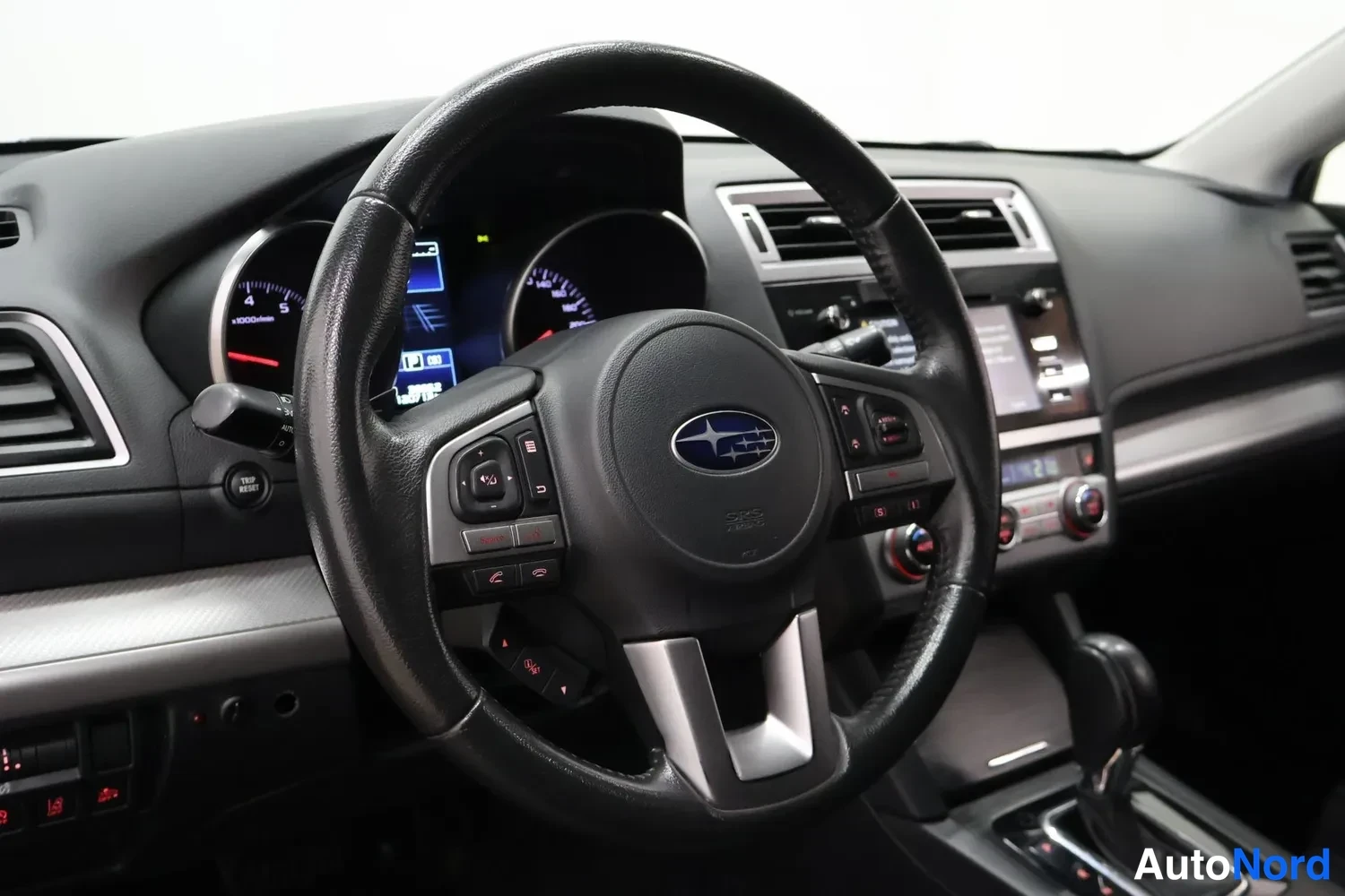 Muu: Kuljettajan näkymä: Subaru-ohjauspyörä, mittaristo ja kojelaudan radio- ja ilmastointilaitteet.