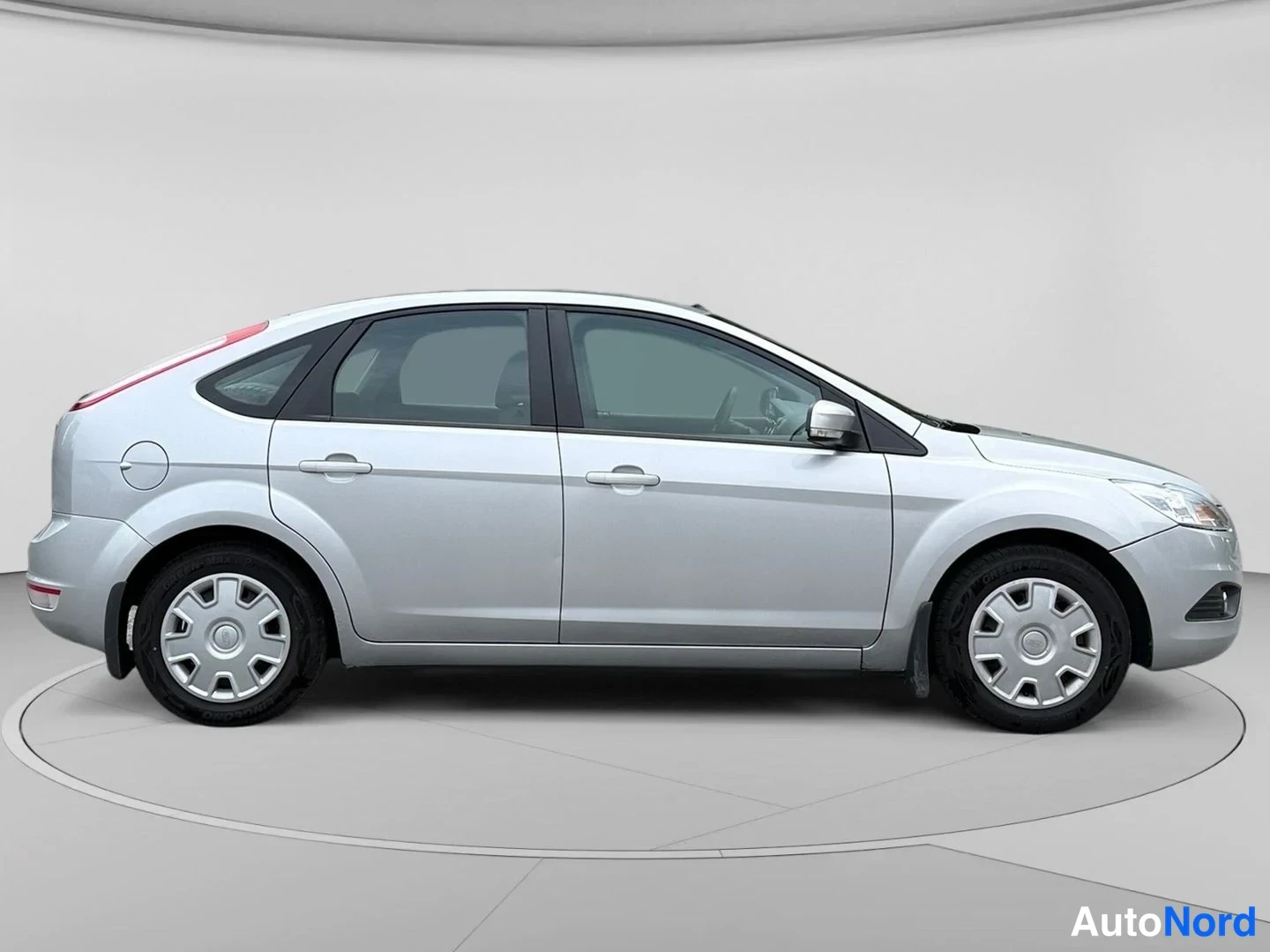 Etuviisto, nokka oikealle: Hopeanvärinen Ford Focus viistoperä sivulta etukulmasta; keulan ajovalot ja korin ovet näkyvät, rekisterikilpi ei luettavissa.