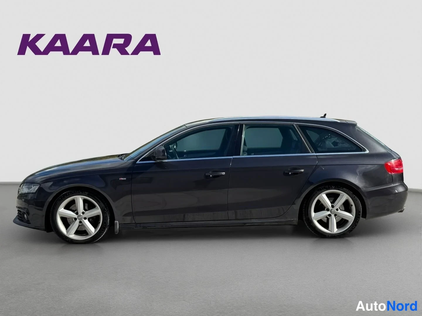 Sivulta: Audi A4 Avant sivulta oikealta: tummanharmaa farmarikori, hopeiset viisipiikkiset kevytmetallivanteet ja kromikoristeet ikkunalinjassa.