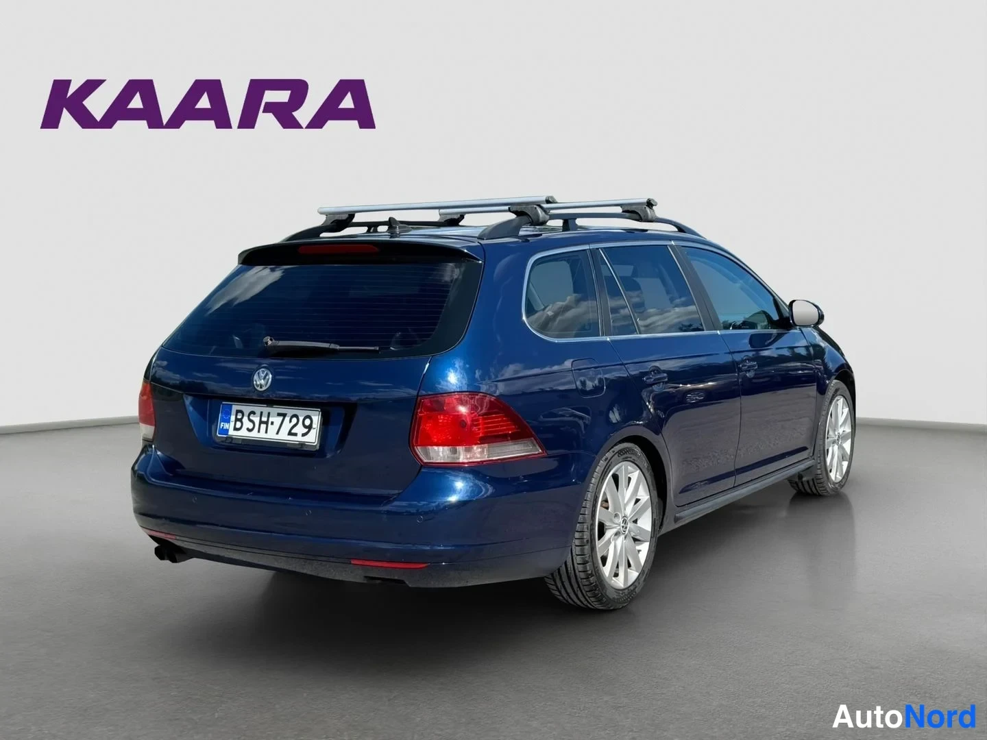 Takaviisto: Sininen Volkswagen Golf Variant -asematakki takaviistosta, takapää, rekisterikilpi ja kattoteline näkyvät.