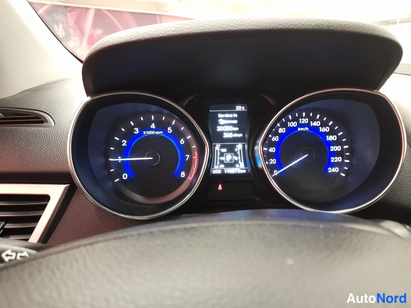 Yksityiskohta: Hyundai i30 -mittaristo, nopeusmittari asteikolla 0–240 km/h, kierrosmittari 0–8, keskellä näyttö jossa teksti 'Service in 30000 km 365 days' ja matkamittari 11