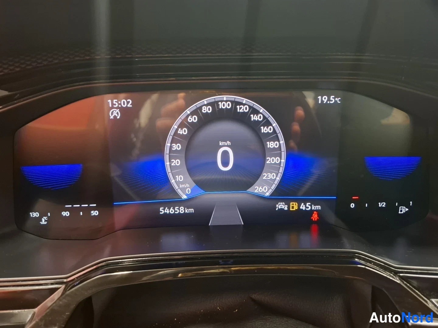 Muu: Volkswagenin digitaalinen mittaristo näyttää 54 658 km matkan, nopeuden 0 km/h, kellonajan 15:02 ja ulkolämpötilan 19,5 °C.