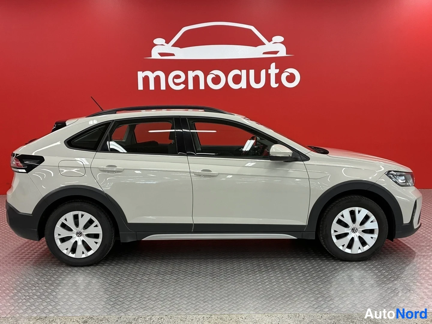 Sivulta: Volkswagen Taigo -henkilöauto sivulta, vaaleanbeige rungo, pelti muodossa on kaari ylös takana.