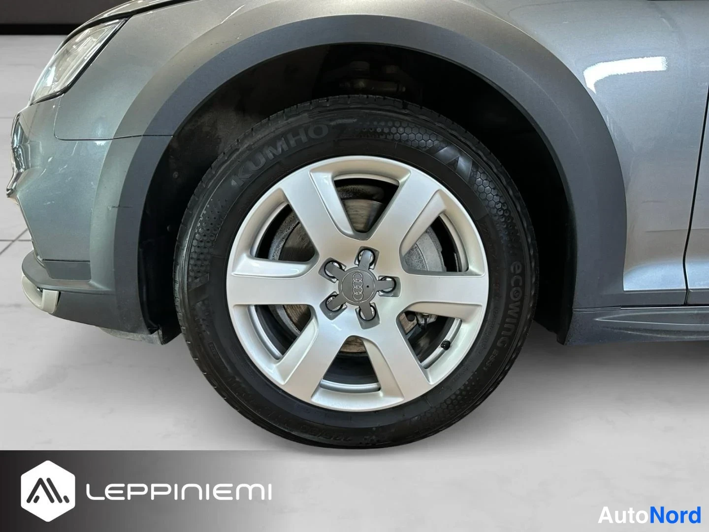 Etuviisto, nokka vasemmalle: Audi A4 Allroadin etupyörän lähikuva: hopeinen peltivanne, Kumho-renkuksen ja etupyörän jarrulevy näkyvät; keulaa ja etusuojusta näkyy vasemmassa reuna