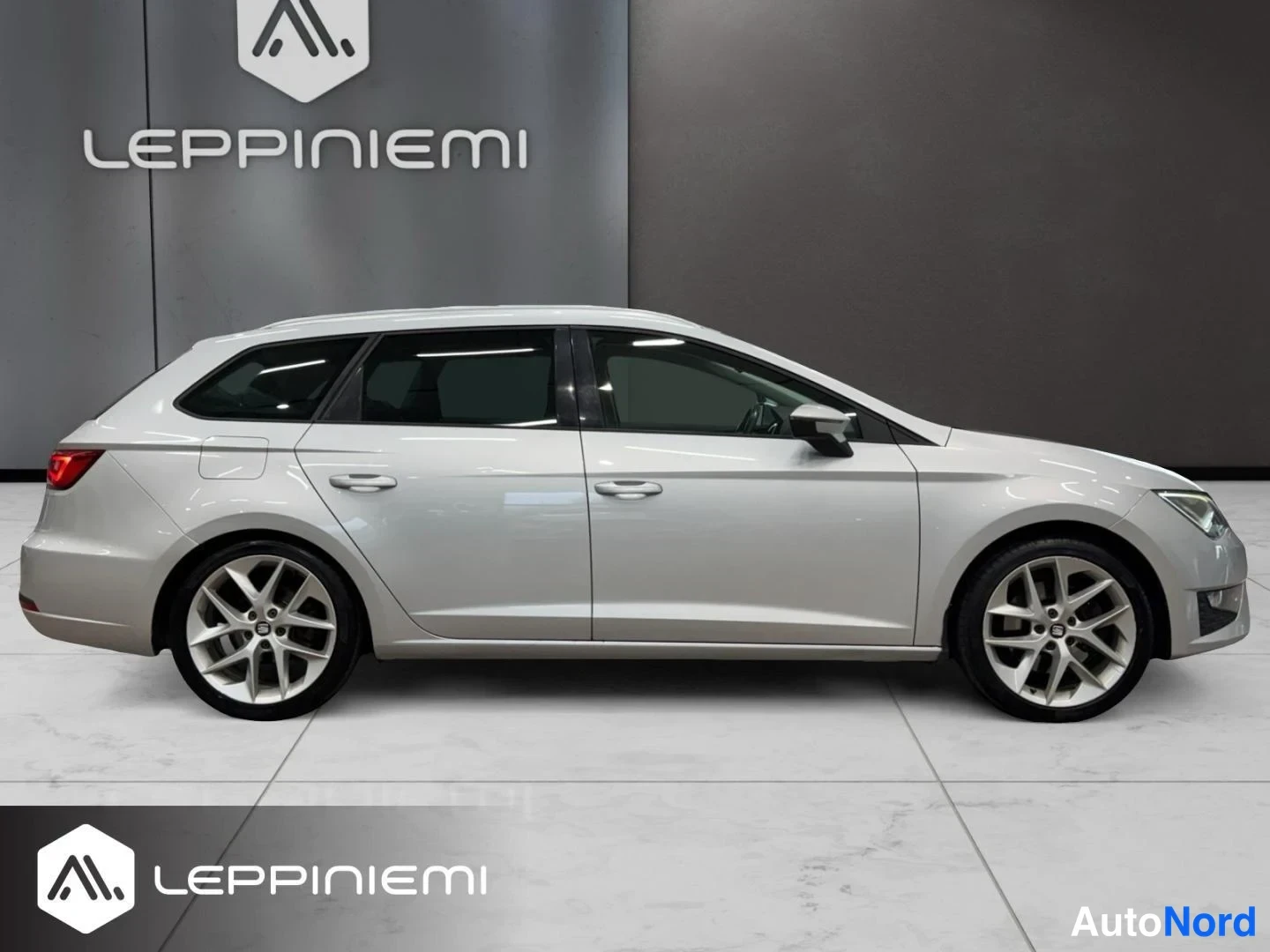Sivulta: Sivunäkymä hopeanvärisestä Seat Leon ST -farmariautosta vasemmalta; näkyvissä kyljen ovet, lasit, takavalojen kulma ja monipuolaiset kevytmetallivanteet.