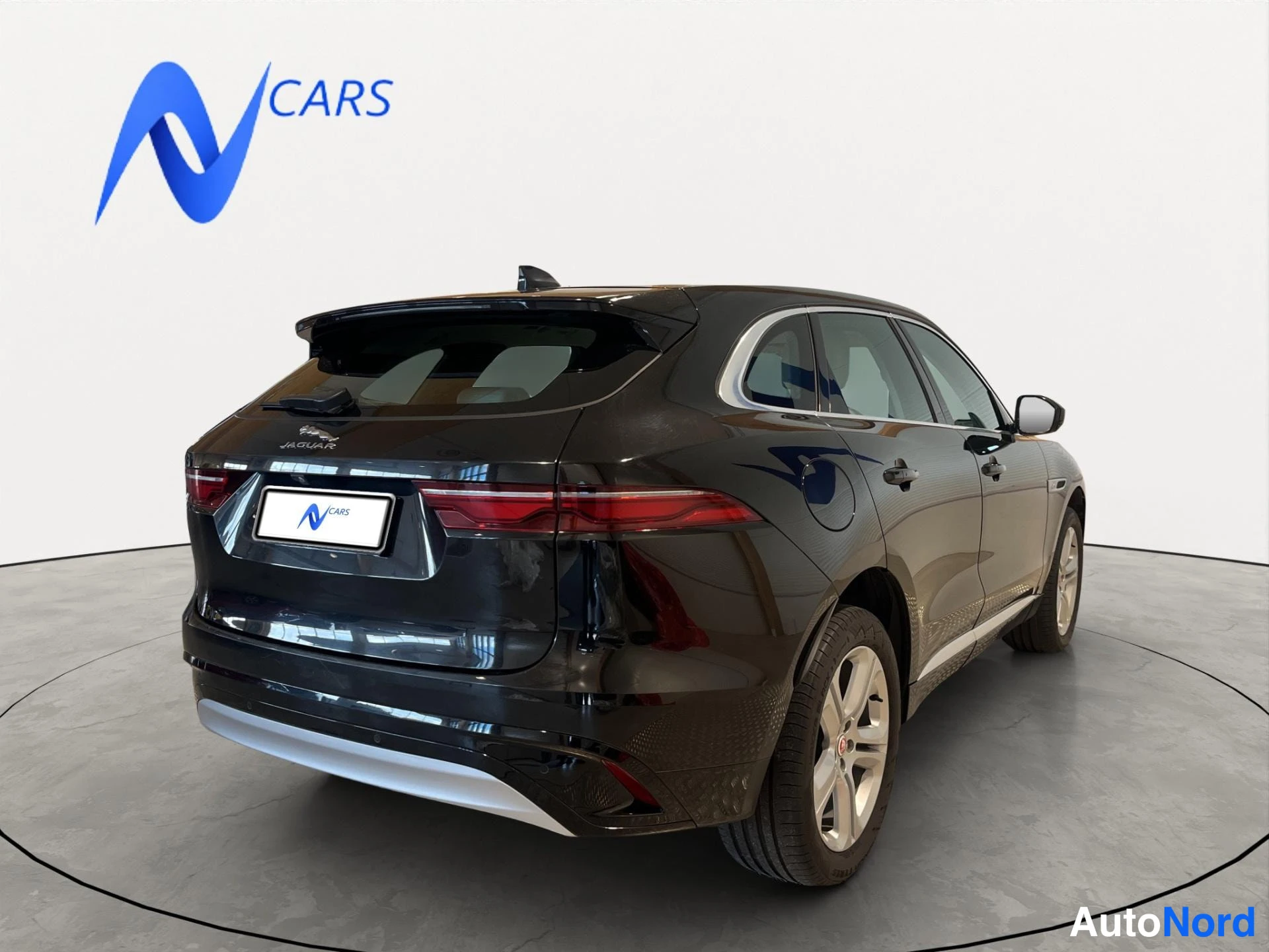 Takaviisto: Jaguar F-Pace farmari takaa oikealta kuvattuna, tumma runko, rekisterikilven tilalla myyjän mainosmerkki.