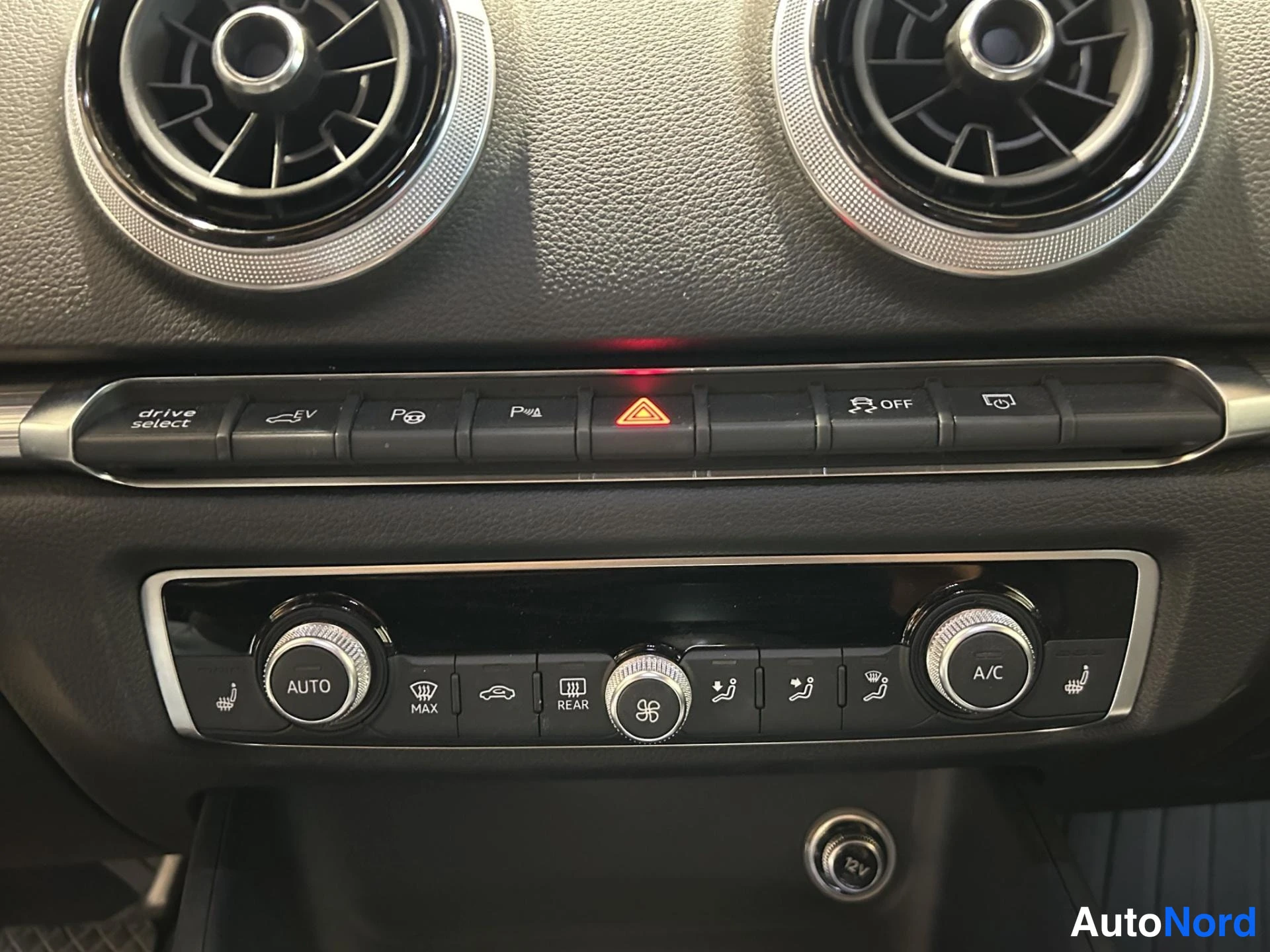 Yksityiskohta: Audi A3:n keskinäyttö, jossa ilmastointiautomaation (AUTO, A/C), drive select-, EV- ja tiettyjen ratsastajien lämmitysasetusten näppäimet.