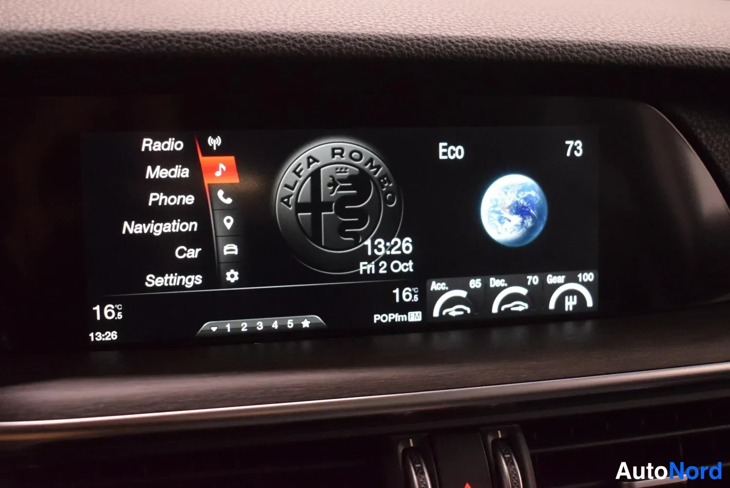 Muu: Infotainment-näyttö valikossa Radio, Media, Phone, Navigation, Car, Settings, Alfa Romeo -logo ja kellonaika 13:26.
