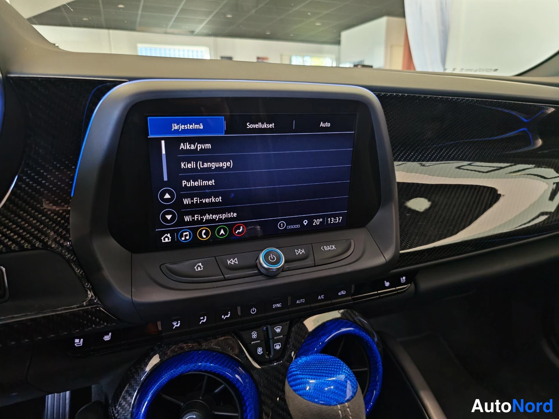Muu: Kojelaudan infotainment-näyttö järjestelmävalikossa vaihtoehdoilla Aika/pvm, Kieli (Language), Puhelimet, Wi-Fi-verkot ja Wi-Fi-yhteyspiste, alla kiertoilmastoi