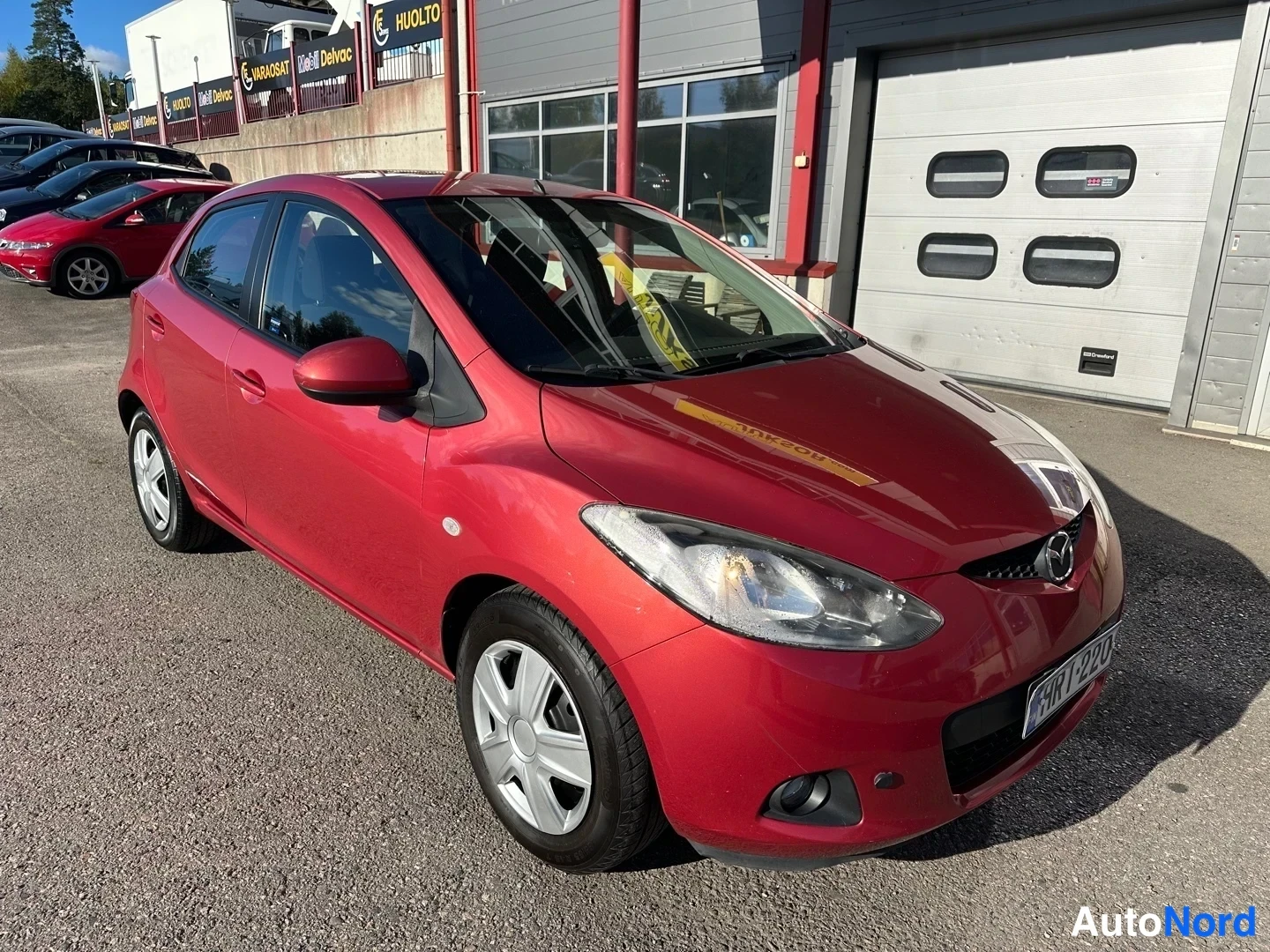 Red Mazda 2 2008, front three-quarter, nose to the right, photo 2