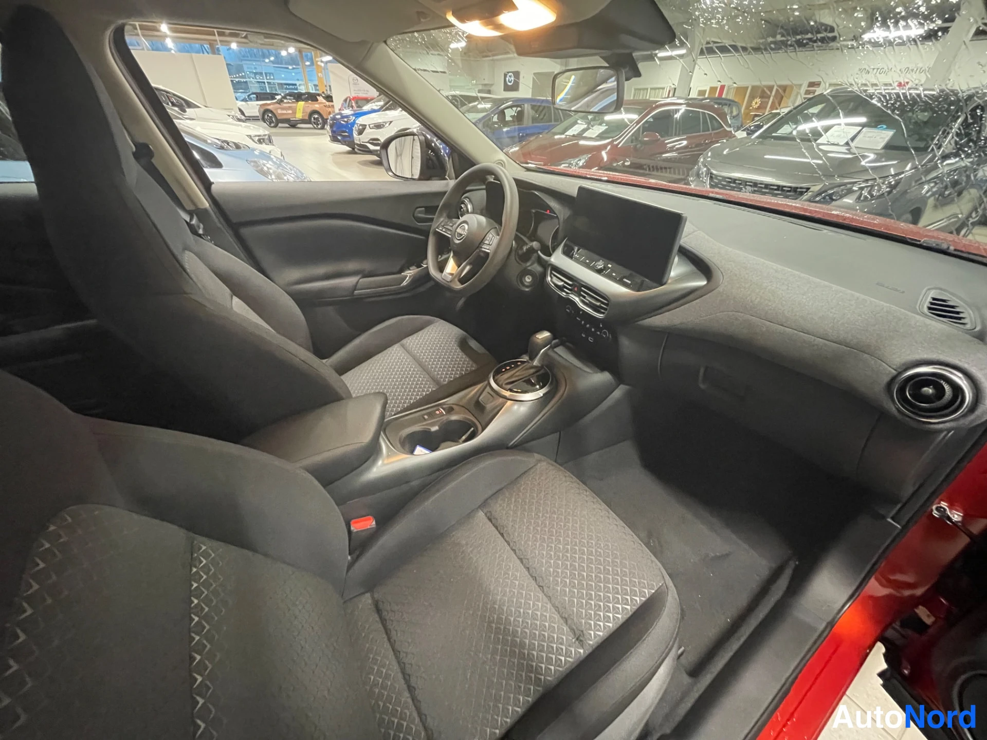 Red Nissan Juke 2026, front three-quarter, nose to the right, photo 5