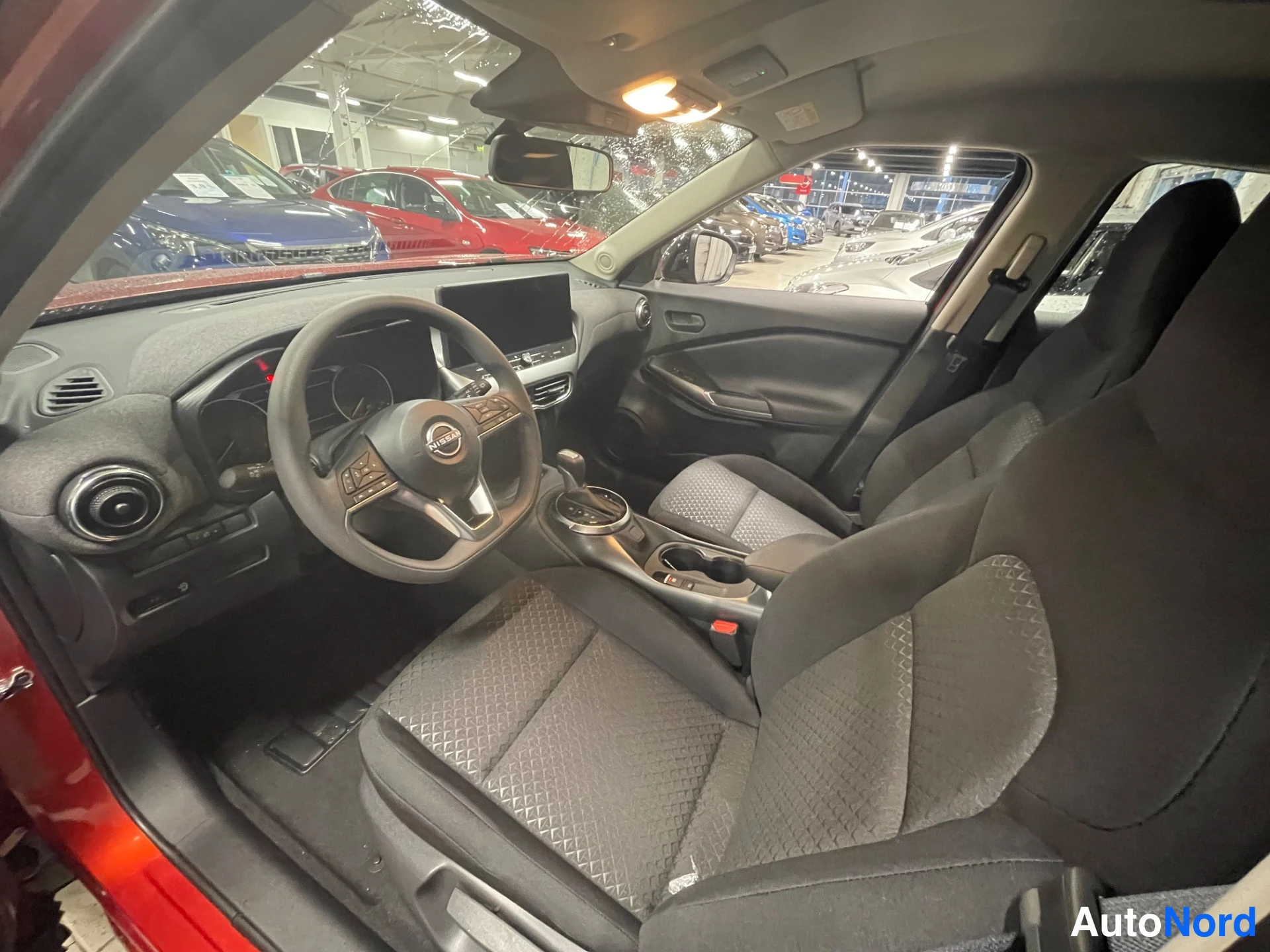 Red Nissan Juke 2026, front three-quarter, nose to the left, photo 3