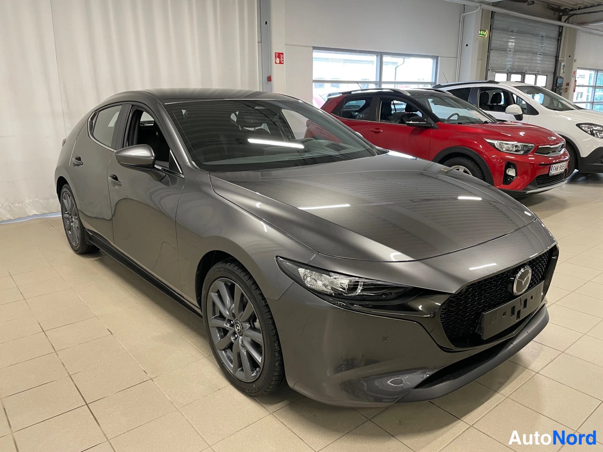 Grey Mazda Mazda3 2026, front three-quarter, nose to the right, photo 2