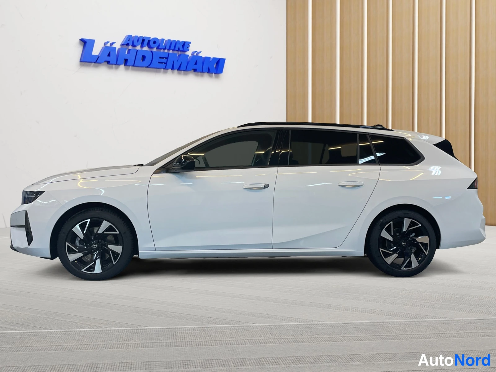 White Opel Astra 2026, front three-quarter, nose to the left, photo 2