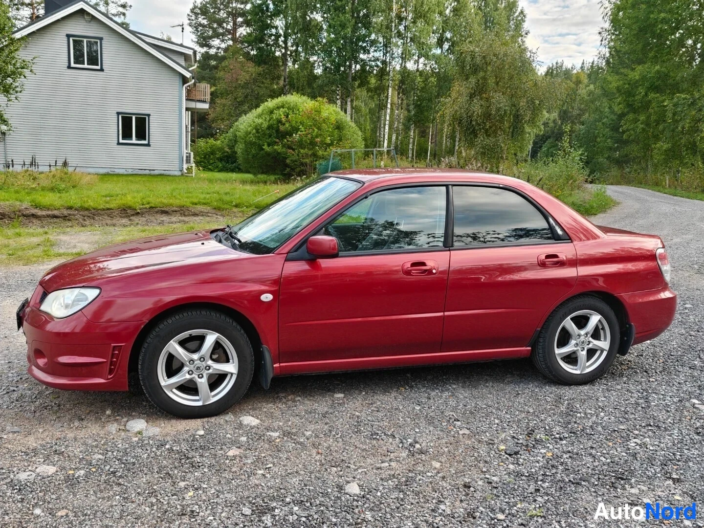 Red Subaru Impreza 2006, front three-quarter, nose to the left, photo 2