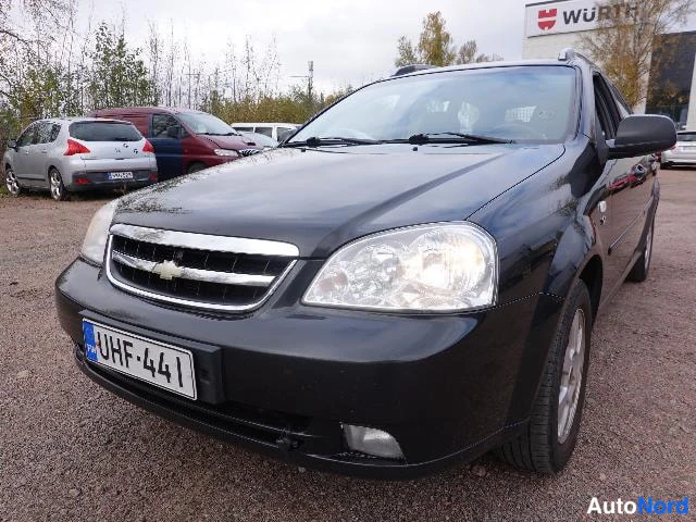 Musta Chevrolet Nubira 2010, etuviisto, keula vasemmalle, kuva 6