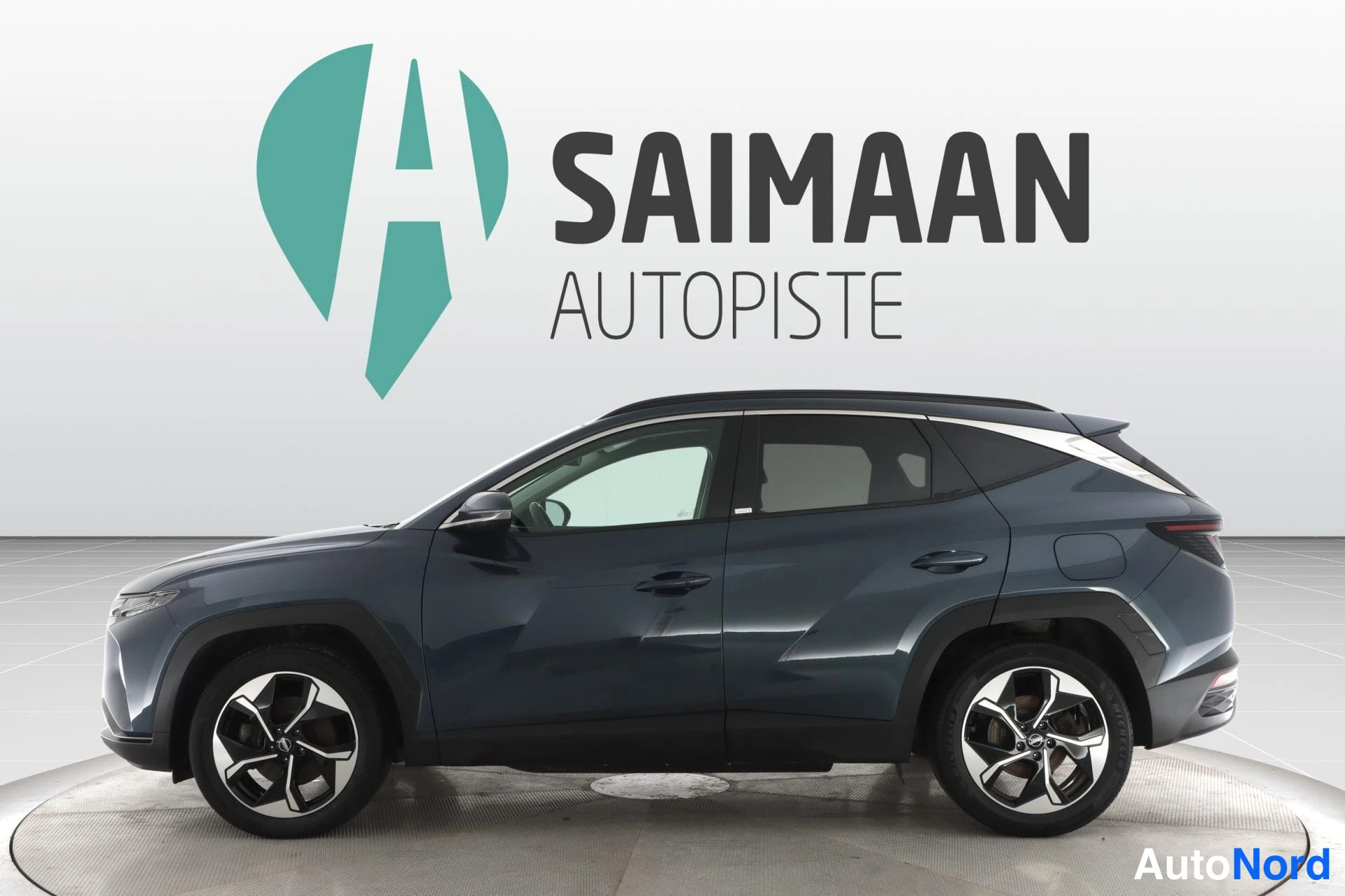 Sininen Hyundai Tucson 2021, etuviisto, keula vasemmalle, kuva 2