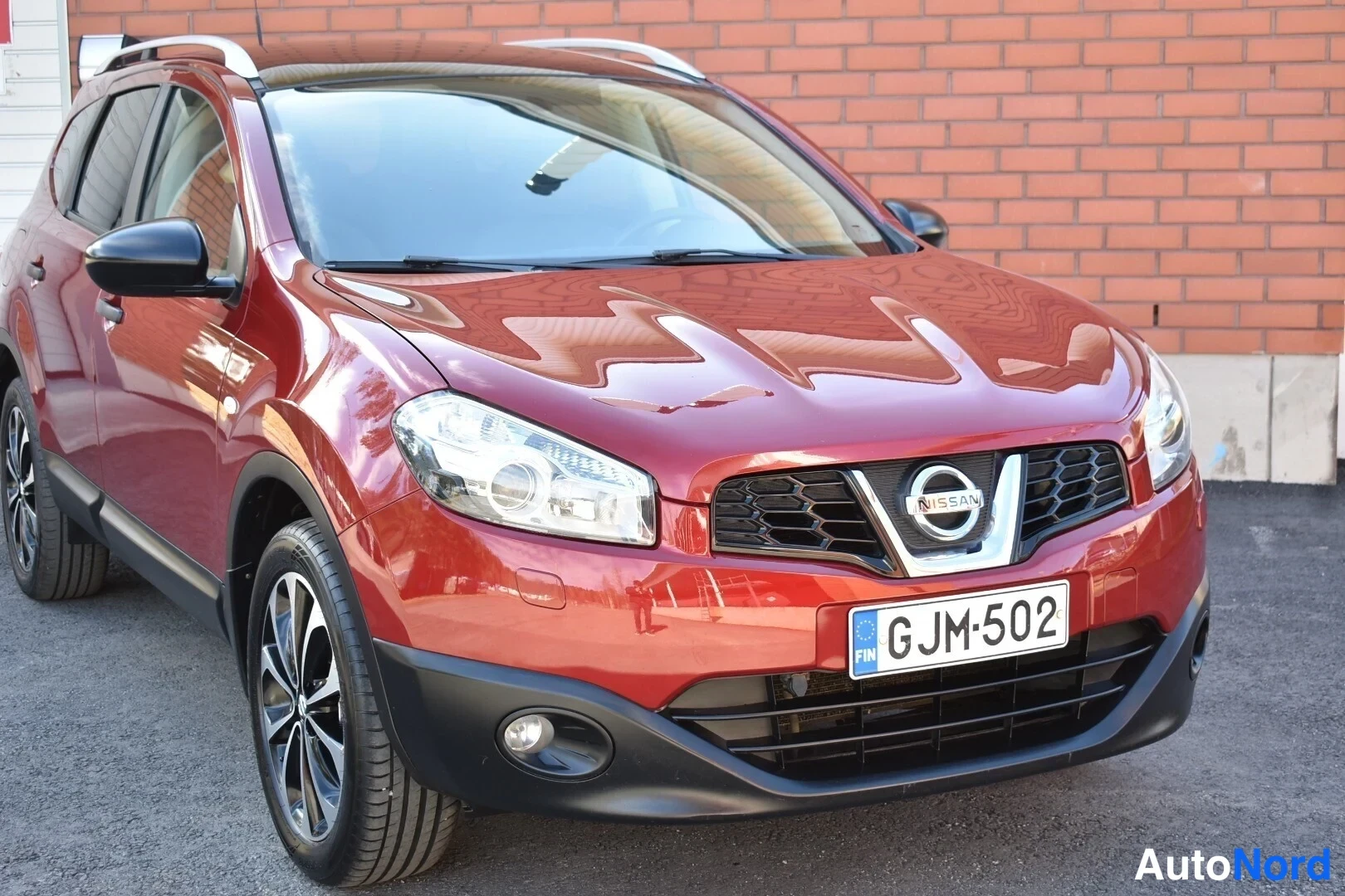 Punainen Nissan Qashqai+2 2010, etuviisto, keula oikealle, kuva 3