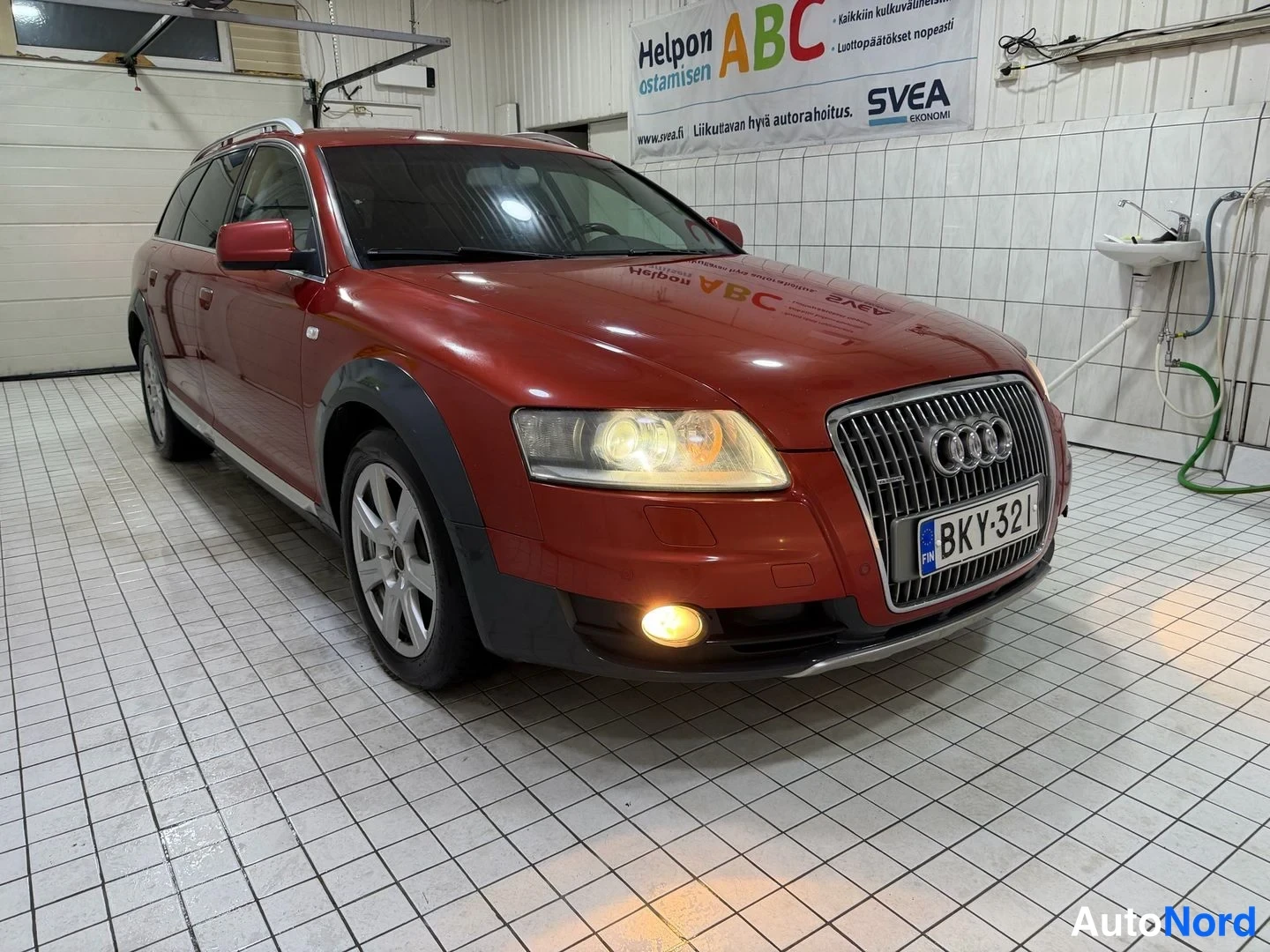 Red Audi A6 allroad quattro 2008, front three-quarter, nose to the right, photo 3