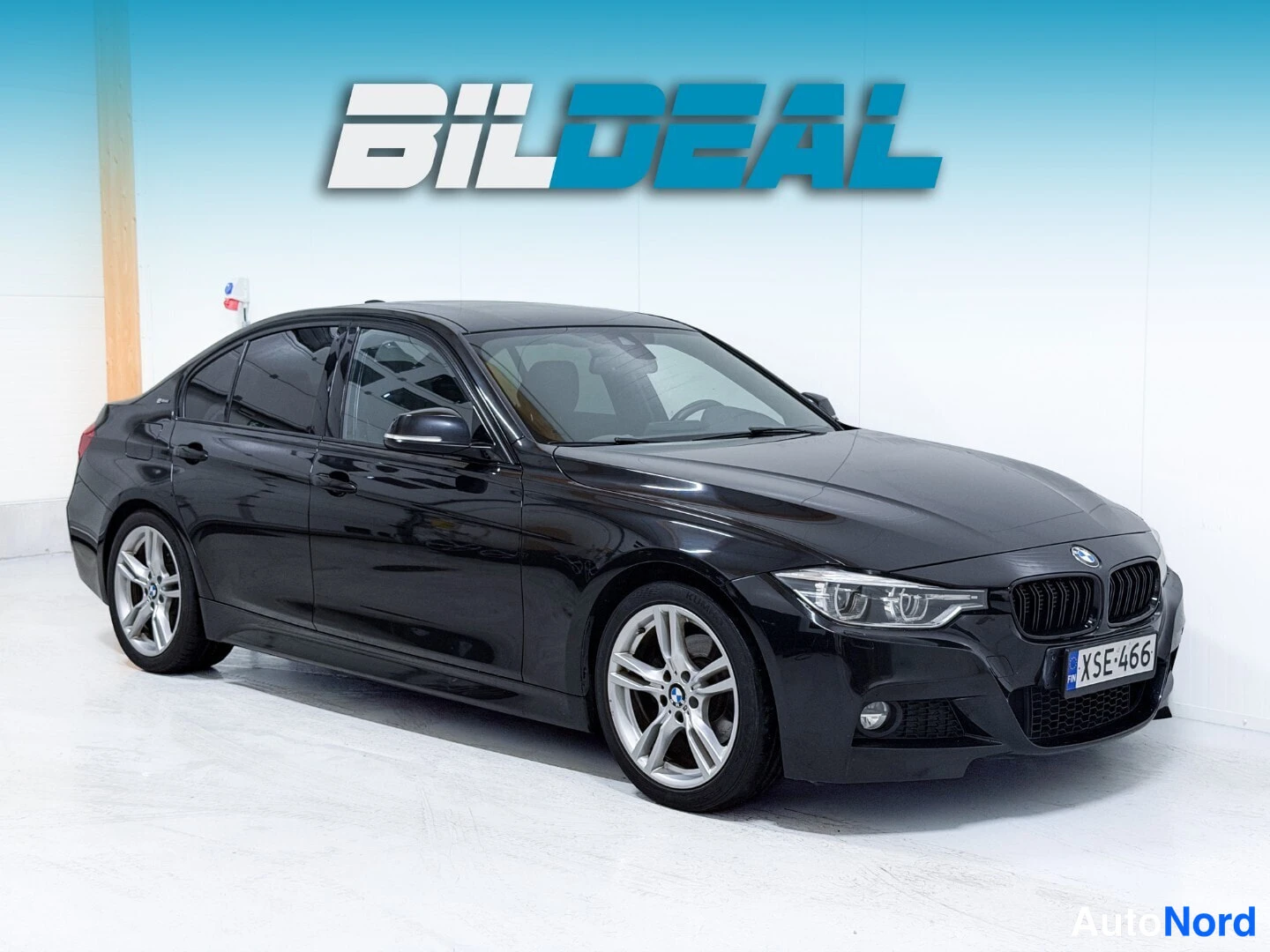 Black BMW 330e 2017, front three-quarter, nose to the right, photo 2