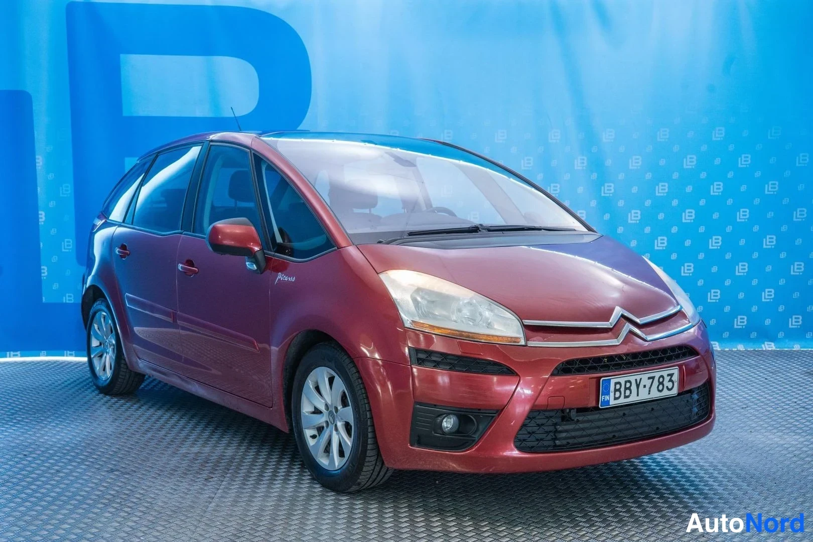 Red Citroen C4 Picasso 2008, front three-quarter, nose to the right, photo 3